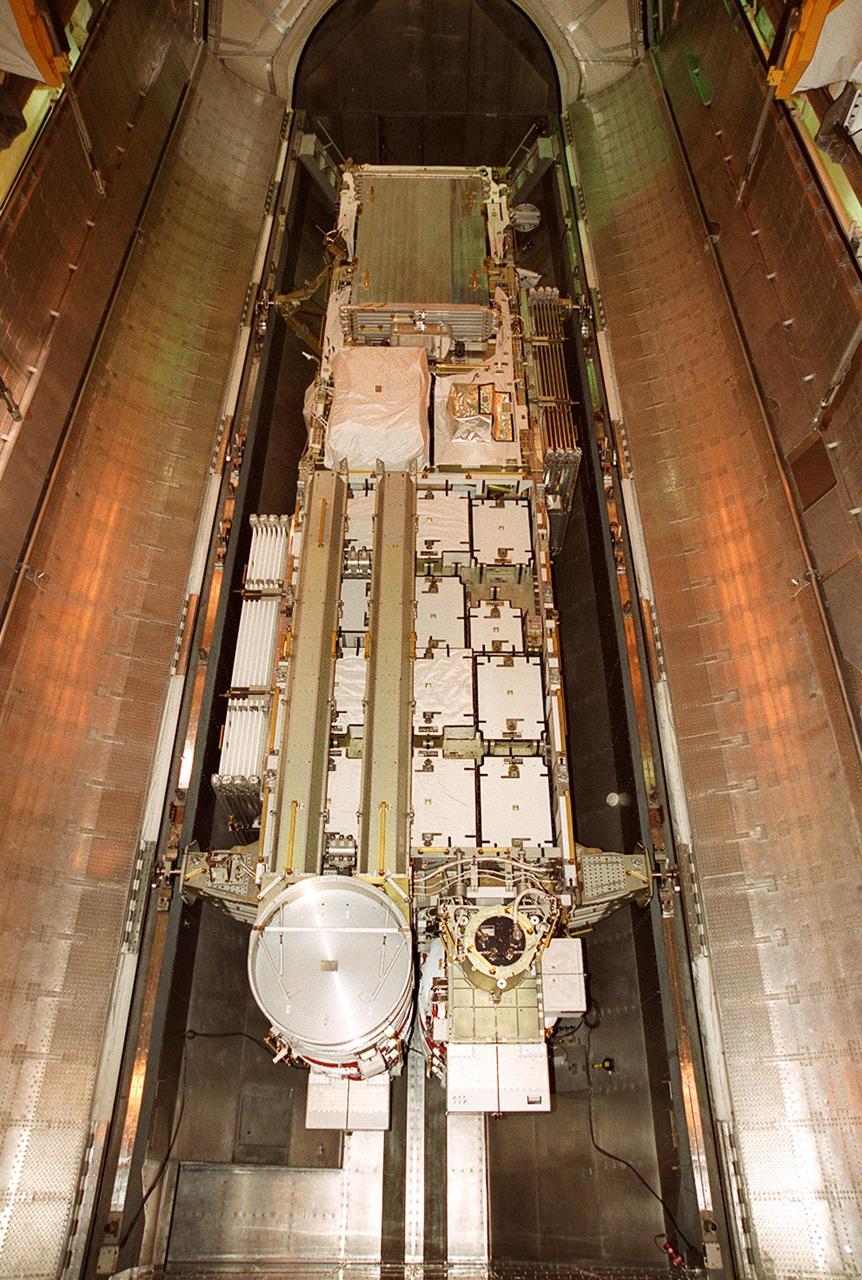 The doors of the payload transport canister are open wide in the payload changeout room on Launch Pad 39B. Revealed is the P6 integrated truss segment, which will fly on mission STS-97. The P6 comprises Solar Array Wing-3 and the Integrated Electronic Assembly, to be installed on the International Space Station. The Station’s electrical power system will use eight photovoltaic solar arrays, each 112 feet long by 39 feet wide, to convert sunlight to electricity. The solar arrays are mounted on a “blanket” that can be folded like an accordion for delivery. Once in orbit, astronauts will deploy the blankets to their full size. Gimbals will be used to rotate the arrays so that they will face the Sun to provide maximum power to the Space Station. Launch of STS-97 is scheduled for Nov. 30 at 10:06 p.m. EST