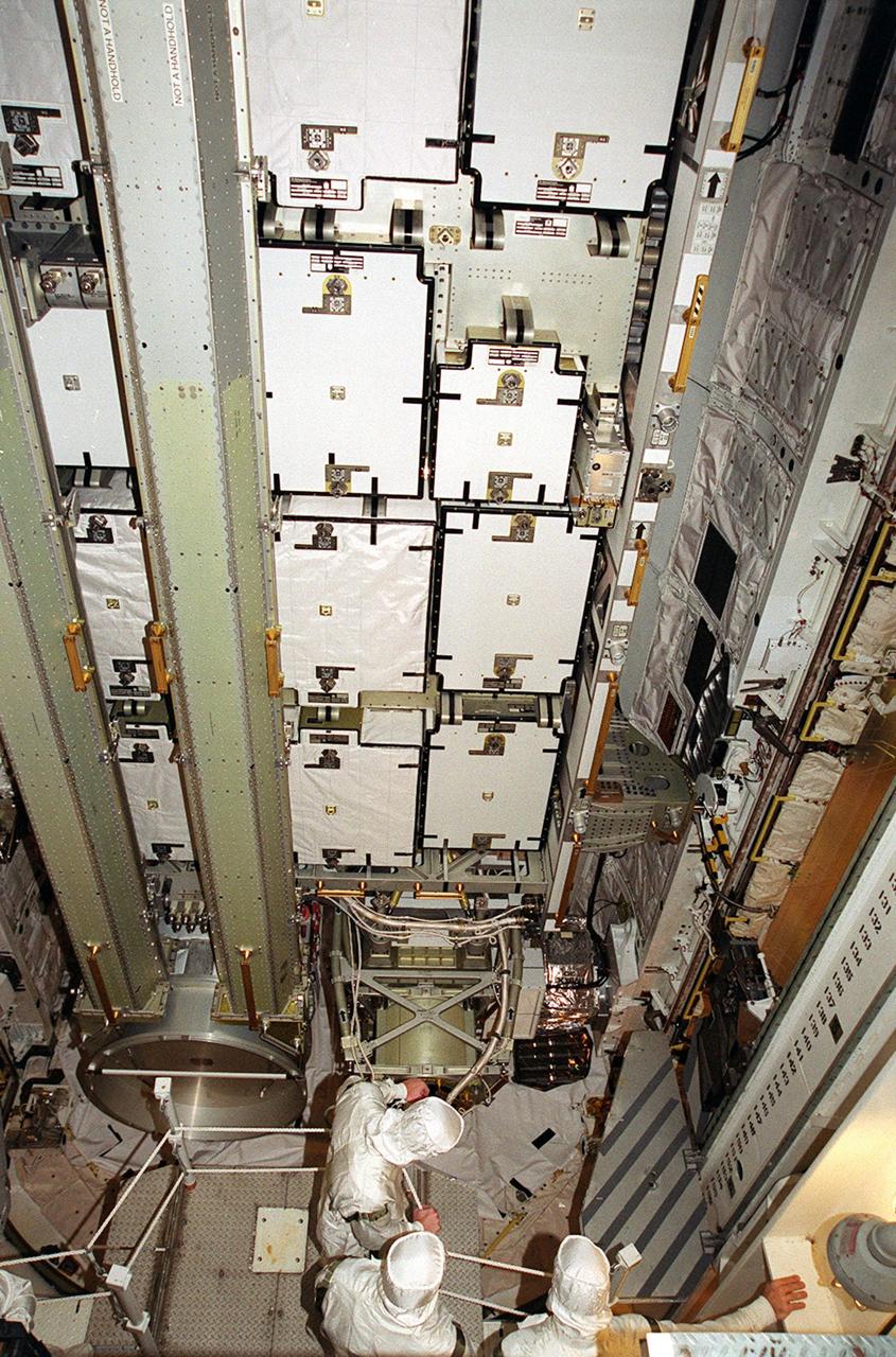 Members of the STS-97 crew take part in payload walkdown inside the payload changeout room at Launch Pad 39B. In the background is seen some of the batteries being carried to the International Space Station on the mission. What appear to be vertical posts at left are the solar arrays. The batteries and solar arrays are part of the P6 Integrated Truss Segment and will be temporarily installed to the Unity connecting module by the Z1 truss, recently delivered to and installed on the Station on mission STS-92. The two solar arrays are each more than 100 feet long. They will capture energy from the sun and convert it to power for the Station. Two spacewalks will be required to install the solar array connections. STS-97 is scheduled to launch Nov. 30 at about 10:06 p.m. EST