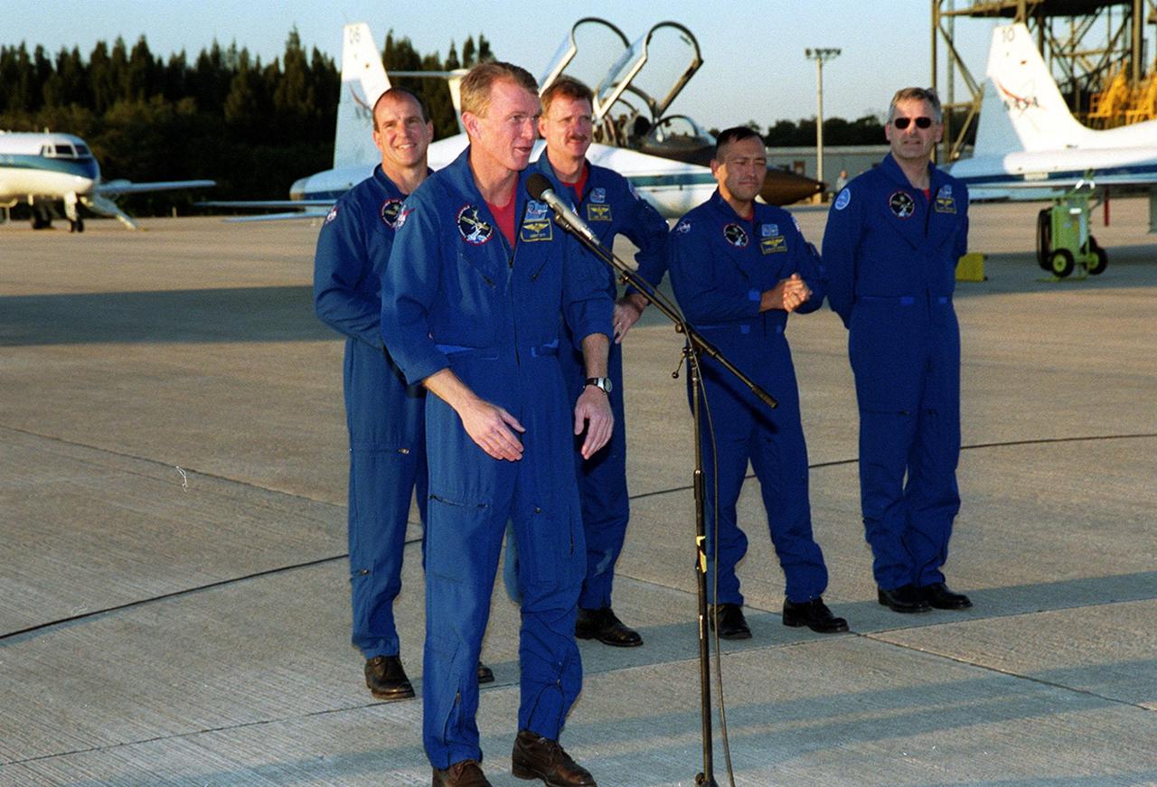 After arriving at the Shuttle Landing Facility, the STS-97 crew gather to address the media. At the microphone, Commander Brent Jett praises the efforts of the KSC workers to get ready for the launch. Behind Jett are Pilot Michael Bloomfield and Mission Specialists Joseph Tanner, Carlos Noriega and Marc Garneau, who is with the Canadian Space Agency. Mission STS-97 is the sixth construction flight to the International Space Station. Its payload includes the P6 Integrated Truss Structure and a photovoltaic (PV) module, with giant solar arrays that will provide power to the Station. The mission includes two spacewalks to complete the solar array connections. STS-97 is scheduled to launch Nov. 30 at about 10:06 p.m. EST