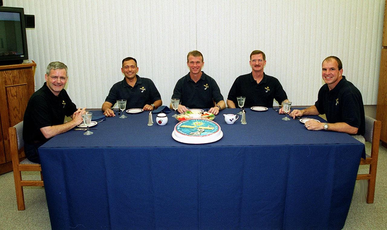 The STS-97 crew are ready to enjoy a snack in the crew quarters, Operations and Checkout Building, before beginning to suit up for launch. Seated from left are Mission Specialists Marc Garneau and Carlos Noriega, Commander Brent Jett, Mission Specialist Joseph Tanner and Pilot Michael Bloomfield. Garneau is with the Canadian Space Agency. Mission STS-97 is the sixth construction flight to the International Space Station. It is transporting the P6 Integrated Truss Structure that comprises Solar Array Wing-3 and the Integrated Electronic Assembly, to be installed on the Space Station. The solar arrays are mounted on a “blanket” that can be folded like an accordion for delivery. Once in orbit, astronauts will deploy the blankets to their full size. The 11-day mission includes two spacewalks to complete the solar array connections. The Station’s electrical power system will use eight photovoltaic solar arrays, each 112 feet long by 39 feet wide, to convert sunlight to electricity.. Gimbals will be used to rotate the arrays so that they will face the Sun to provide maximum power to the Space Station. Launch is scheduled for Nov. 30 at 10:06 p.m. EST