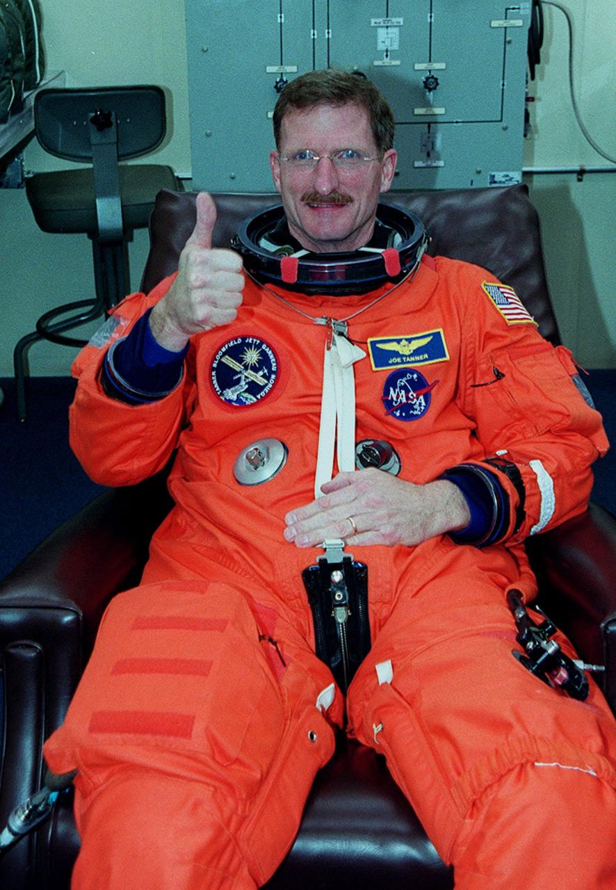 STS-97 Mission Specialist Joseph Tanner signals thumbs up for launch as he dons his launch and entry suit. this is his third Shuttle flight.; Mission STS-97 is the sixth construction flight to the International Space Station. It is transporting the P6 Integrated Truss Structure that comprises Solar Array Wing-3 and the Integrated Electronic Assembly, to be installed on the Space Station. The solar arrays are mounted on a “blanket” that can be folded like an accordion for delivery. Once in orbit, astronauts will deploy the blankets to their full size. The 11-day mission includes two spacewalks to complete the solar array connections. The Station’s electrical power system will use eight photovoltaic solar arrays, each 112 feet long by 39 feet wide, to convert sunlight to electricity.. Gimbals will be used to rotate the arrays so that they will face the Sun to provide maximum power to the Space Station. Launch is scheduled for Nov. 30 at 10:06 p.m. EST