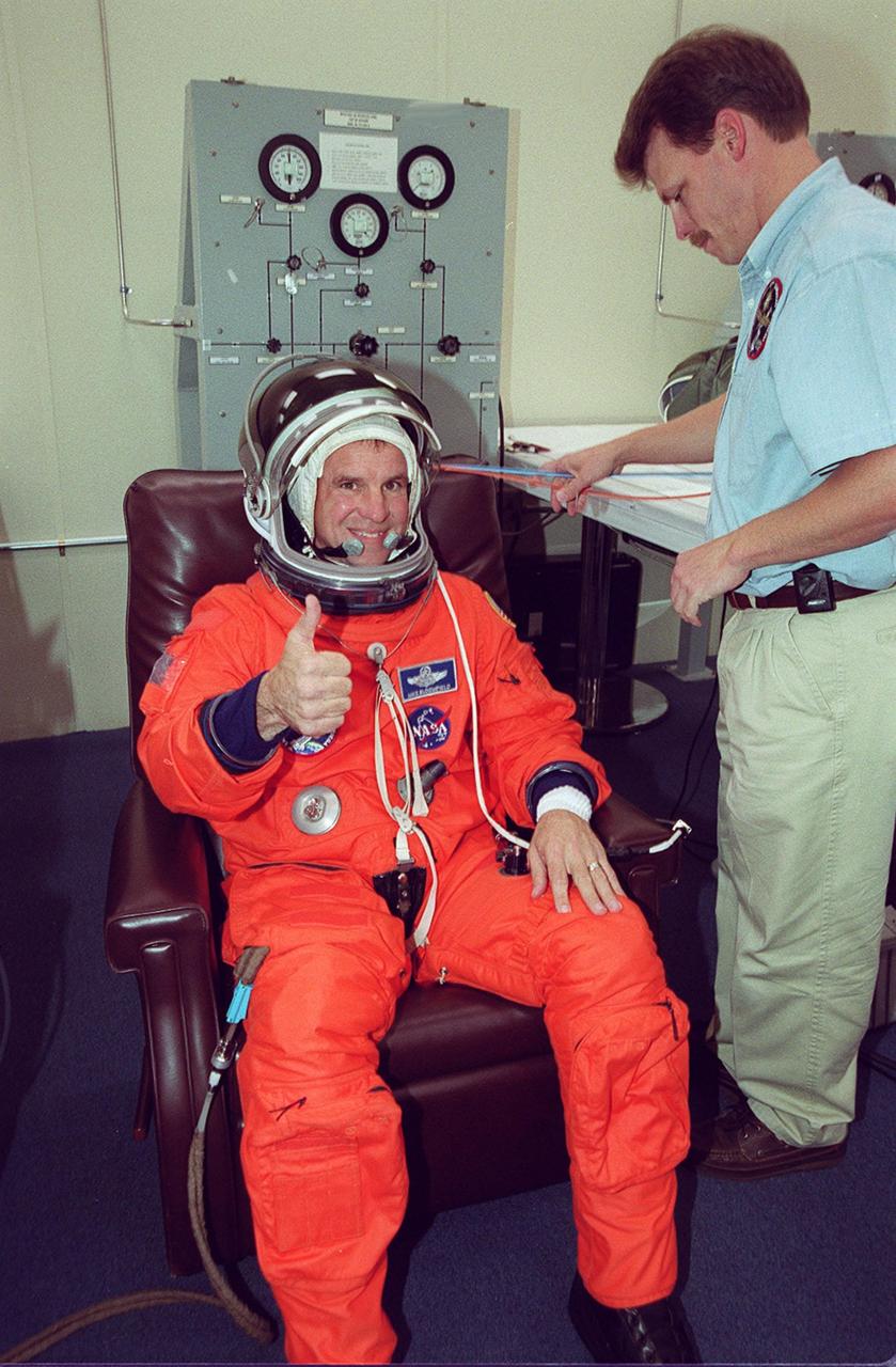 STS-97 Pilot Michael Bloomfield signals thumbs up for launch after donning his launch and entry suit. This is his second Shuttle flight. Mission STS-97 is the sixth construction flight to the International Space Station. It is transporting the P6 Integrated Truss Structure that comprises Solar Array Wing-3 and the Integrated Electronic Assembly, to be installed on the Space Station. The solar arrays are mounted on a “blanket” that can be folded like an accordion for delivery. Once in orbit, astronauts will deploy the blankets to their full size. The 11-day mission includes two spacewalks to complete the solar array connections. The Station’s electrical power system will use eight photovoltaic solar arrays, each 112 feet long by 39 feet wide, to convert sunlight to electricity. Gimbals will be used to rotate the arrays so that they will face the Sun to provide maximum power to the Space Station. Launch is scheduled for Nov. 30 at 10:06 p.m. EST