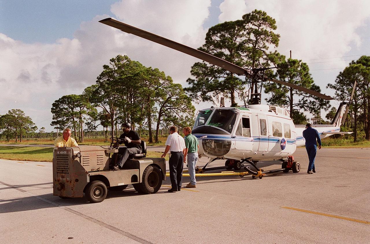 KENNEDY SPACE CENTER, FLA. -- A NASA helicopter is secured for transfer to Ransom Road at KSC. It is one of four UH-1H helicopters that will have its blades painted, changing the black to a pattern of white and yellow stripes. The pattern provides better visibility in smoke and fire conditions. When the rotors are turning, the stripes create a yellow and white circle that is more easily seen by a second helicopter from above. The helicopters, primarily used for security and medical evacuation for NASA, will be used to deliver water via buckets during brush fires. The change was made to comply with U.S. Fish and Wildlife and Department of Forestry regulations for helicopter-assisted fire control