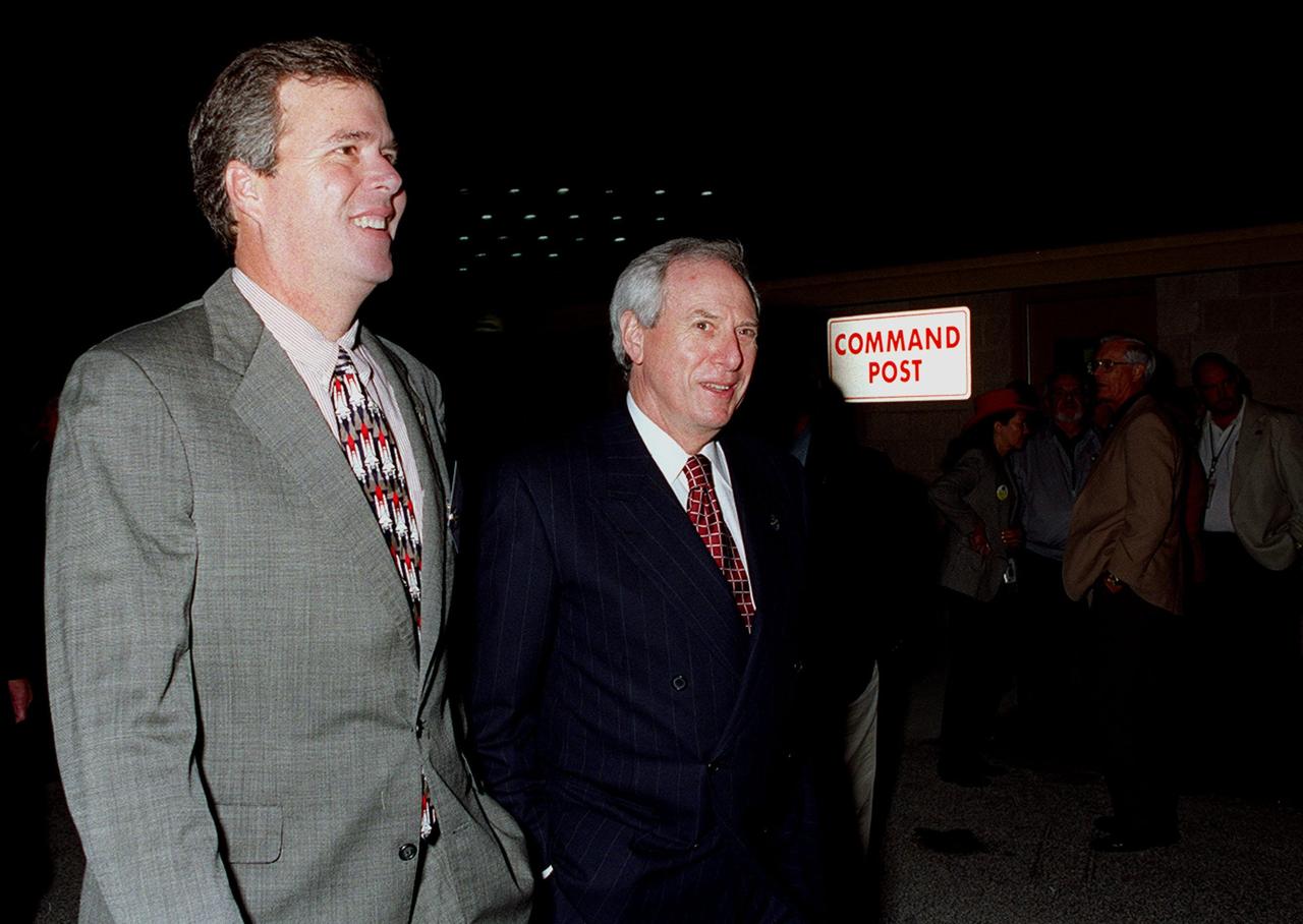 KENNEDY SPACE CENTER, FLA. -- Florida’s Gov. Jeb Bush (left) joins NASA Administrator Daniel Goldin (right) for the launch of Space Shuttle Endeavour on mission STS-97. They viewed the launch from the Banana Creek VIP Site. Liftoff of Endeavour occurred on time at 10:06:01 p.m. EST with a crew of five. The sixth construction flight to the International Space Station, Endeavour is transporting the P6 Integrated Truss Structure that comprises Solar Array Wing-3 and the Integrated Electronic Assembly, to provide power to the Space Station. The 11-day mission includes two spacewalks to complete the solar array connections. Endeavour is expected to land Dec. 11 at 6:19 p.m. EST