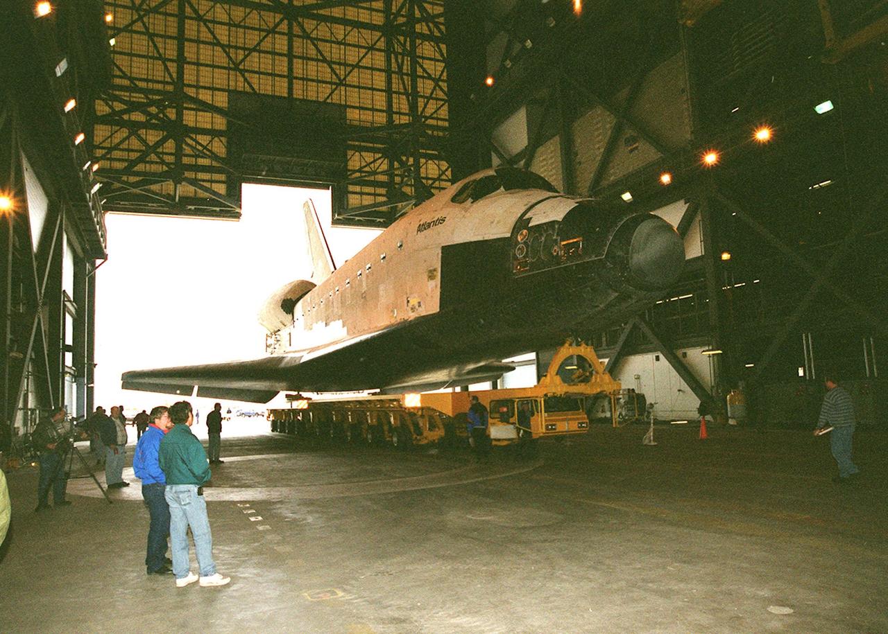 Atlantis rolls into the transfer aisle of the Vehicle Assembly Building where it will be raised to vertical and lifted into high bay 3 for stacking with its external tank and solid rocket boosters. Atlantis will fly on mission STS-98, the seventh construction flight to the International Space Station. The orbiter will carry in its payload bay the U.S. Laboratory, named Destiny, that will have five system racks already installed inside of the module. After delivery of electronics in the lab, electrically powered attitude control for Control Moment Gyroscopes will be activated. Atlantis is scheduled for launch on Jan. 18, 2001, at 2:44 a.m. EST, with a crew of five