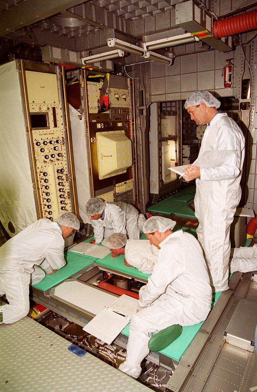 KENNEDY SPACE CENTER, Fla. -- During In-Flight Maintenance training for their mission, STS-107 crew members check equipment and paperwork inside the SPACEHAB Double Module. From left to right are Pilot William C. "Willie" McCool; Payload Specialist Ilan Ramon; Mission Specialists Michael Anderson and David M. Brown; and Commander Rick D. Husband. As a research mission, STS-107 will carry the SPACEHAB Double Module in its first research flight into space and a broad collection of experiments ranging from material science to life science. STS-107 is scheduled to launch July 19, 2001