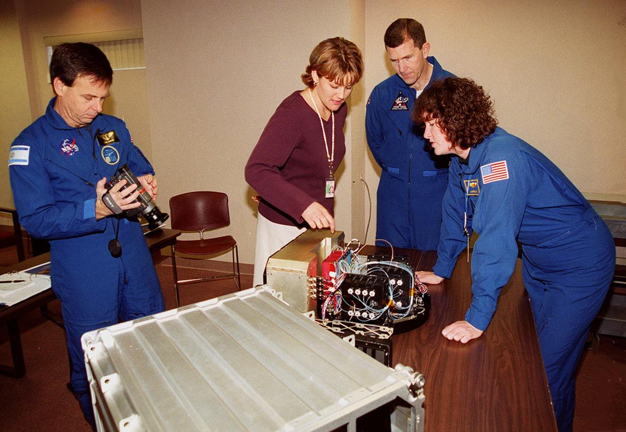 KENNEDY SPACE CENTER, FLA. -- Members of the STS-107 crew are taking part in In-Flight Maintenance training. Payload Specialist Ilan Ramon of Israel, project engineer April Boody, Commander Rick D. Husband and Mission Specialist Laurel Clark look over a Biotube experiment. As a research mission, STS-107 will carry the SPACEHAB Double Module in its first research flight into space and a broad collection of experiments ranging from material science to life science. It is scheduled to launch July 19, 2001
