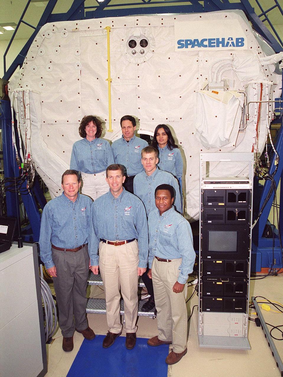 KENNEDY SPACE CENTER, Fla. -- Taking part in In-Flight Maintenance training, the STS-107 crew poses in front of the SPACEHAB Double Module. In back are Mission Specialist Laurel Clark, Payload Specialist Ilan Ramon of Israel, and Mission Specialist Kalpana Chawla; in front are Mission Specialist David M. Brown, Commander Rick D. Husband, Pilot William C. “Willie” McCool (behind) and Mission Specialist Michael Anderson. As a research mission, STS-107 will carry the SPACEHAB Double Module in its first research flight into space and a broad collection of experiments ranging from material science to life science. It is scheduled to launch July 19, 2001