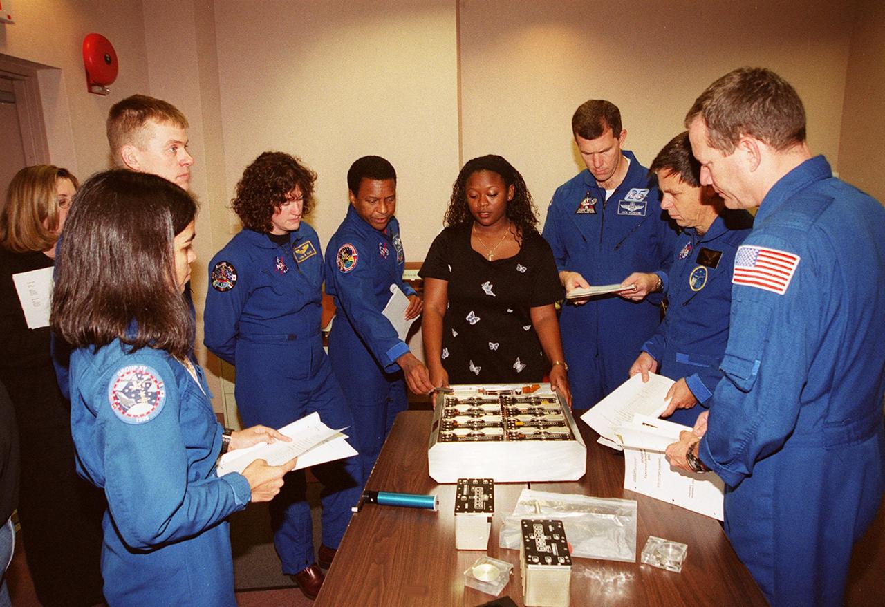 As part of In-Flight Maintenance training at SPACEHAB, in Cape Canaveral, Fla., members of the STS-107 crew learn about Biological Research in Canisters (BRIC) experiments that will be on their mission. Gathered around the table are (from left) Mission Specialist Kalpana Chawla, Pilot William C. “Willie” McCool, Mission Specialists Laurel Clark and Michael Anderson, Roberteen McCray of Bionetics, Commander Rick D. Husband, Payload Specialist Ilan Ramon of Israel and Mission Specialist David M. Brown. STS-107 will carry a broad collection of experiments ranging from material science to life science. It is scheduled to launch July 19, 2001