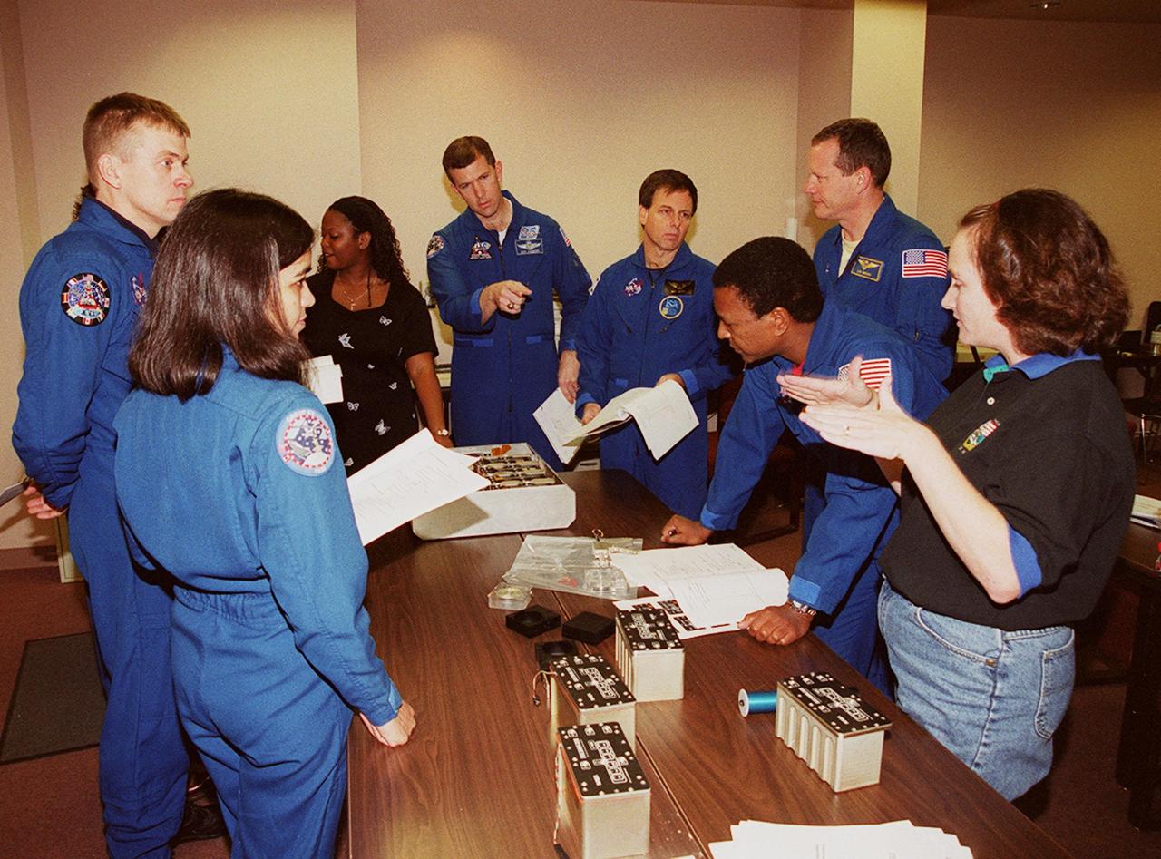 KENNEDY SPACE CENTER, FLA. -- As part of In-Flight Maintenance training at SPACEHAB, in Cape Canaveral, Fla., the STS-107 crew learns about Biological Research in Canisters (BRIC) experiments that will be on their mission. From left are Mission Specialist Kalpana Chawla, Pilot William C. “Willie” McCool, Roberteen McCray of Bionetics, Commander Rick D. Husband, Payload Specialist Ilan Ramon of Israel, and Mission Specialists David M. Brown and Michael Anderson. At right is Debbie Wells of Bionetics. Not seen is Mission Specialist Laurel Clark. STS-107 will carry a broad collection of experiments ranging from material science to life science. It is scheduled to launch July 19, 2001