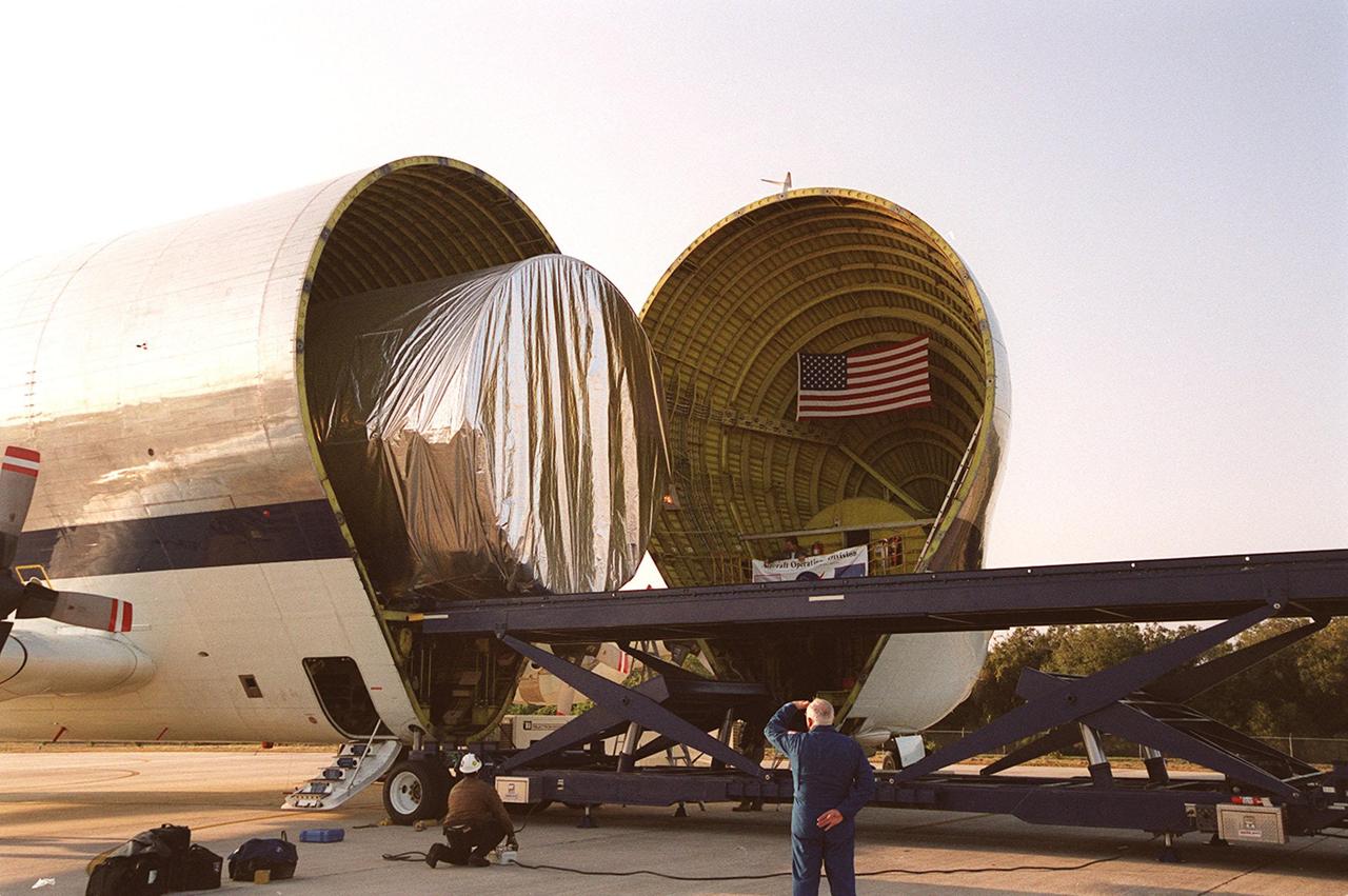 On the parking apron of the KSC Shuttle Landing Facility, the Integrated Truss Structure S3 moves out from inside the Super Guppy aircraft that brought it to KSC from Tulsa, Okla. After offloading, the S3 will be transported to the Operations and Checkout Building. The second starboard truss segment of the International Space Station, the S3 truss is scheduled to be added to the Station in April 2003