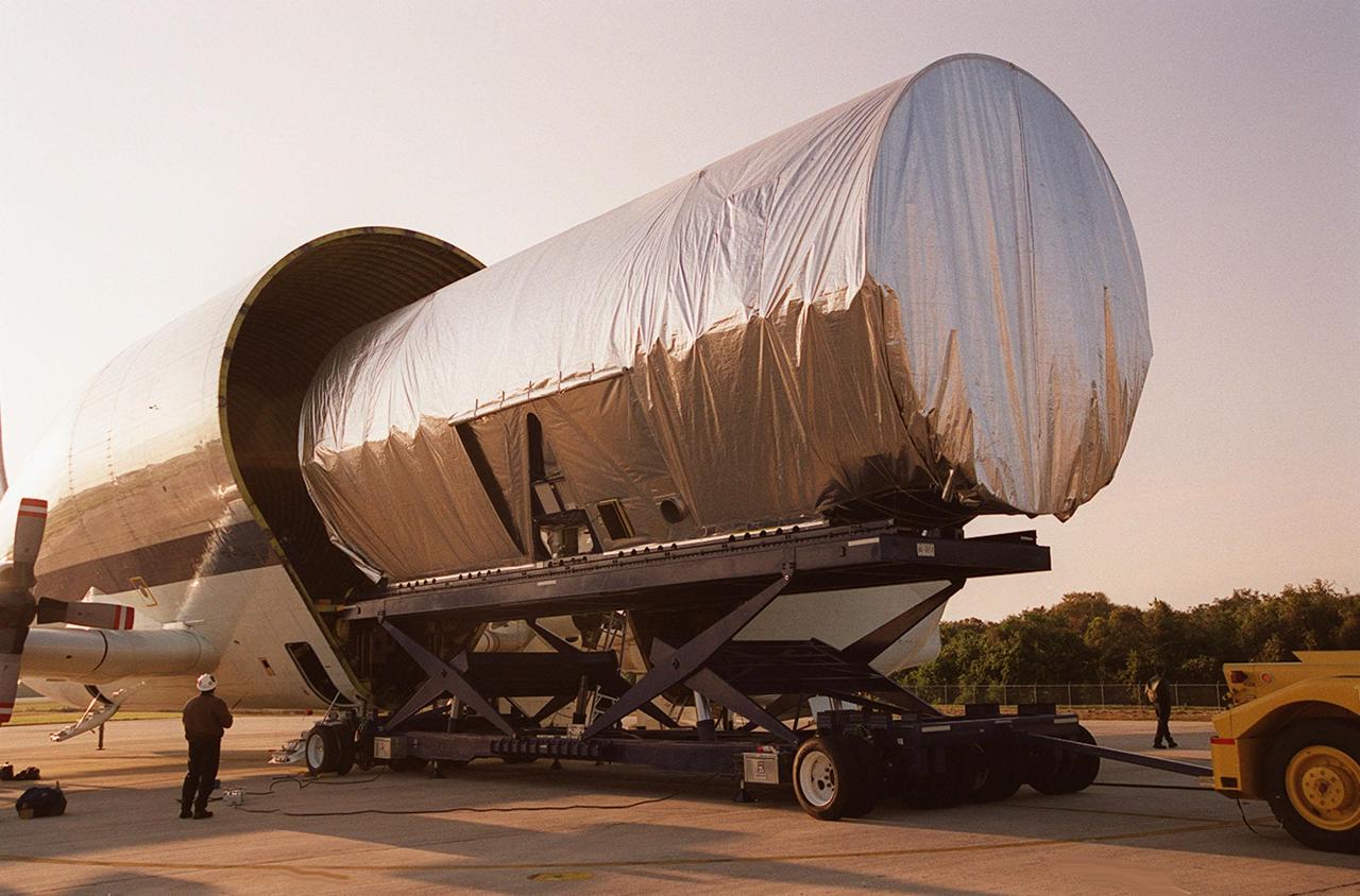 The Integrated Truss Structure S3 is offloaded from the Super Guppy aircraft that brought it to KSC from Tulsa, Okla. The S3 is built by The Boeing Co. The truss will be transported to the Operations and Checkout Building. The second starboard truss segment of the International Space Station, the S3 truss is scheduled to be added to the Station in April 2003