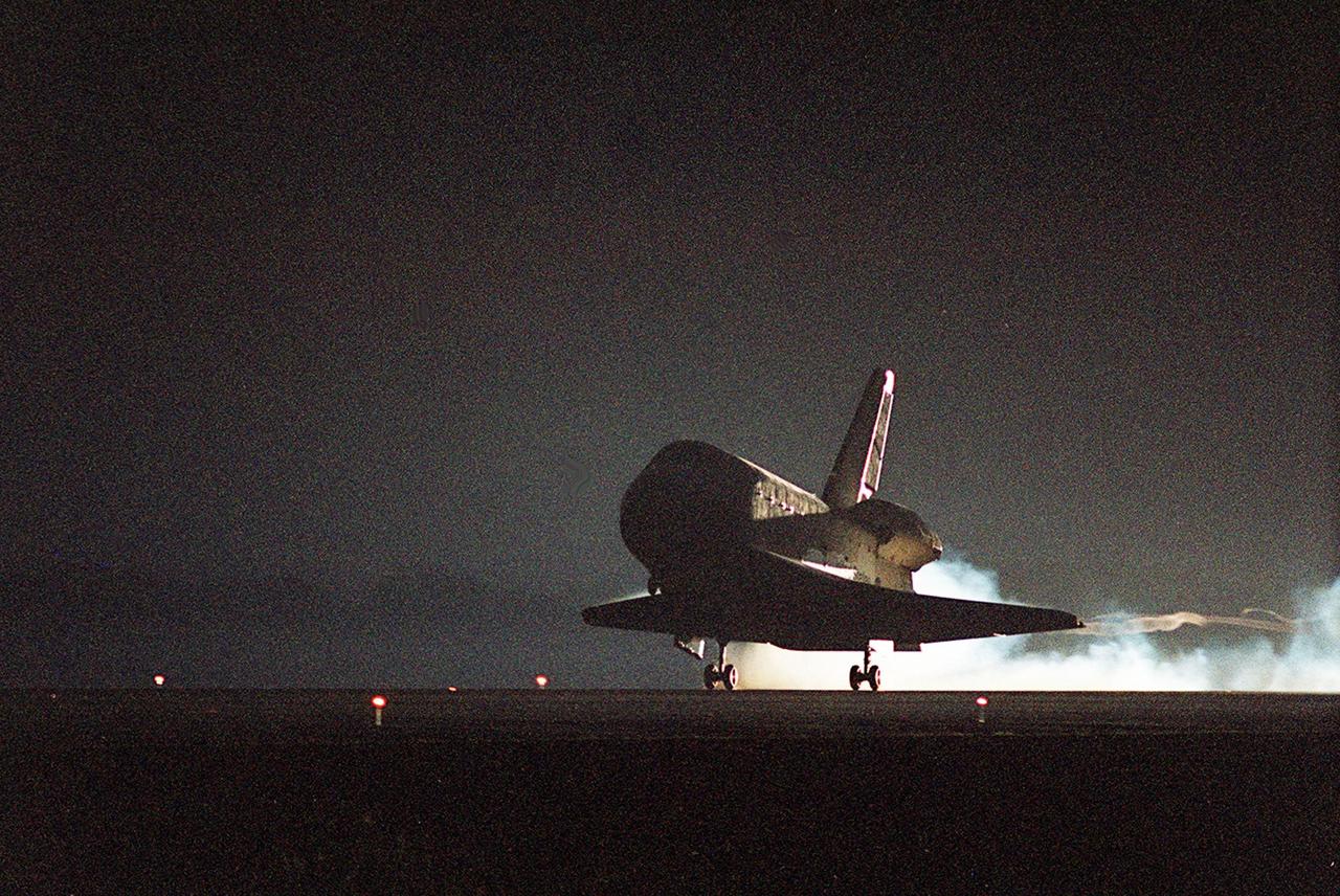 KENNEDY SPACE CENTER, Fla. -- In the waning light after sunset, Endeavour’s main gear touches down on Runway 15 at the Shuttle Landing Facility at 6:03 p.m. EST. At the controls is Commander Brent Jett, completing the successful 10-day, 19-hour and 58-minute-long STS-97 mission. Other crew members on board are Pilot Michael Bloomfield and Mission Specialists Joseph Tanner, Carlos Noriega and Marc Garneau of Canada. On the 4.4-million-mile mission, Endeavour carried the P6 Integrated Truss Structure with solar arrays to power the International Space Station. The arrays and other equipment were installed during three EVAs that totaled 19 hours, 20 minutes. Endeavour was docked with the Space Station for 6 days, 23 hours, 13 minutes. This is the 16th nighttime landing for a Space Shuttle and the 53rd at Kennedy Space Center