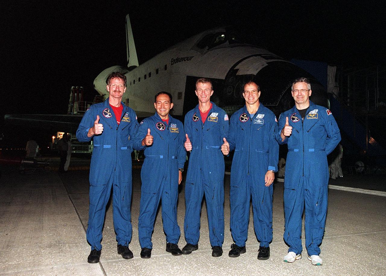 KENNEDY SPACE CENTER, FLA. -- The STS-97 crew pauses for a photograph before heading for crew quarters. They landed safely at the SLF at 6:04 p.m. EST after a successful mission. From the left are Mission Specialists Joseph Tanner and Carlos Noriega, Commander Brent Jett, Pilot Michael Bloomfield and Mission Specialist Marc Garneau of Canada. Endeavour carried the P6 Integrated Truss Structure with solar arrays to power the International Space Station. The arrays and other equipment were installed during three EVAs that totaled 19 hours, 20 minutes. Endeavour was docked with the Space Station for 6 days, 23 hours, 13 minutes. This was the 16th nighttime landing for a Space Shuttle and the 53rd at Kennedy Space Center