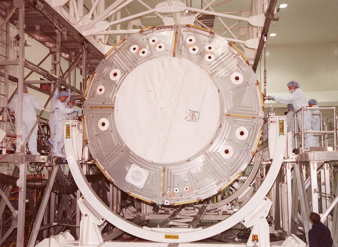 KENNEDY SPACE CENTER, FLA. --  In the Space Station Processing Facility, workers attach an overhead crane to the U.S. Lab Destiny. The lab is being moved from its test and integration stand to the Launch Package Integration Stand (LPIS) for a weight and center of gravity determination. Destiny is the payload aboard Space Shuttle Atlantis on mission STS-98 to the International Space Station. The lab is fitted with five system racks and will already have experiments installed inside for the flight. The launch is scheduled for January 2001
