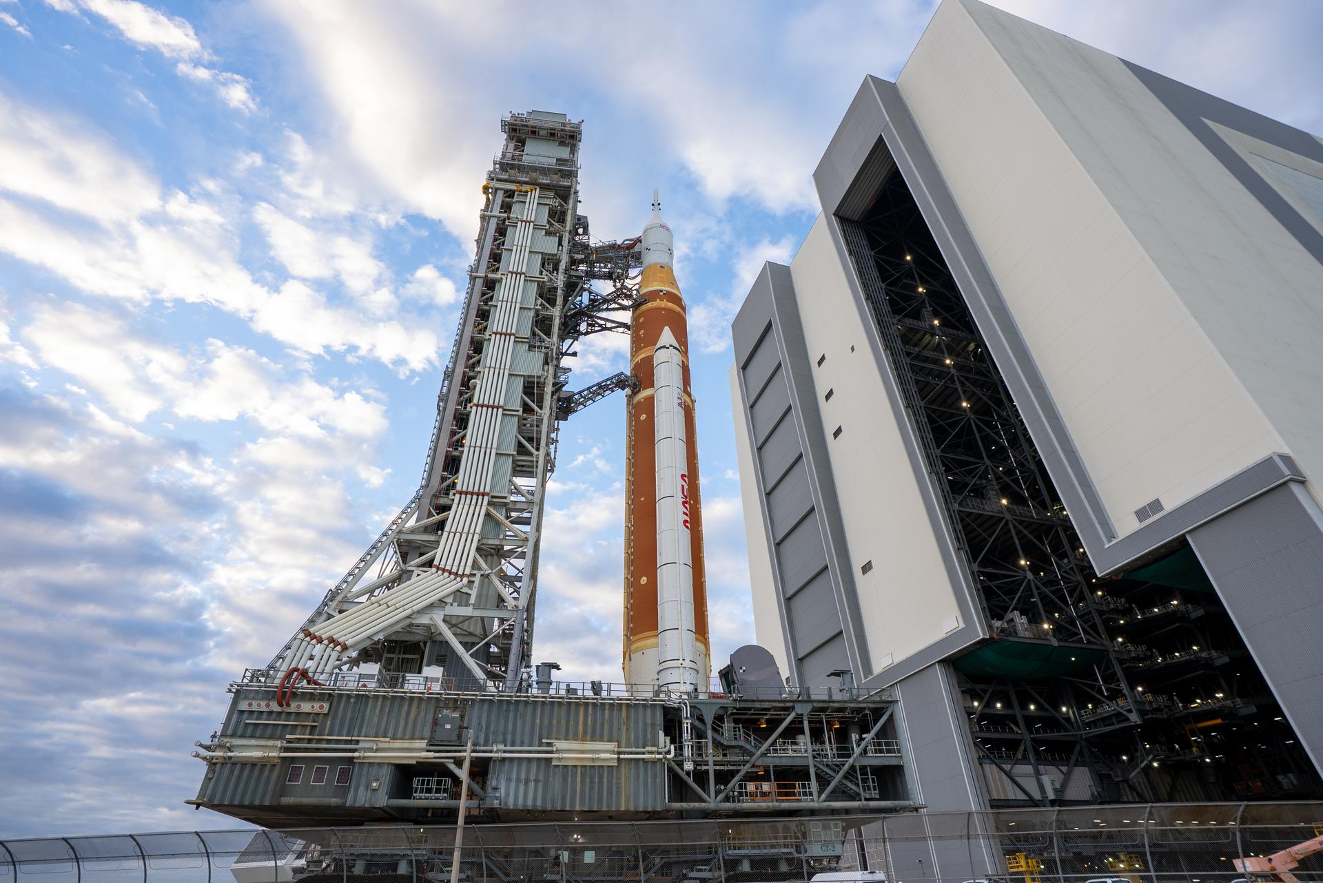 This image shows NASA’s SLS (Space Launch System) and Orion spacecraft rolling out of the Vehicle Assembly Building at NASA’s Kennedy Space Center. NASA's massive Crawler-Transporter, upgraded for the Artemis program, carries the powerful SLS rocket and Orion spacecraft on the Mobile Launcher from the Vehicle Assembly Building to Launch Pad 39B at Kennedy Space Center in preparation for the Artemis II mission.