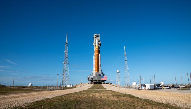 This image shows NASA’s SLS (Space Launch System) and Orion spacecraft rollin...