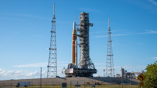 This image shows NASA’s SLS (Space Launch System) and Orion spacecraft rollin...