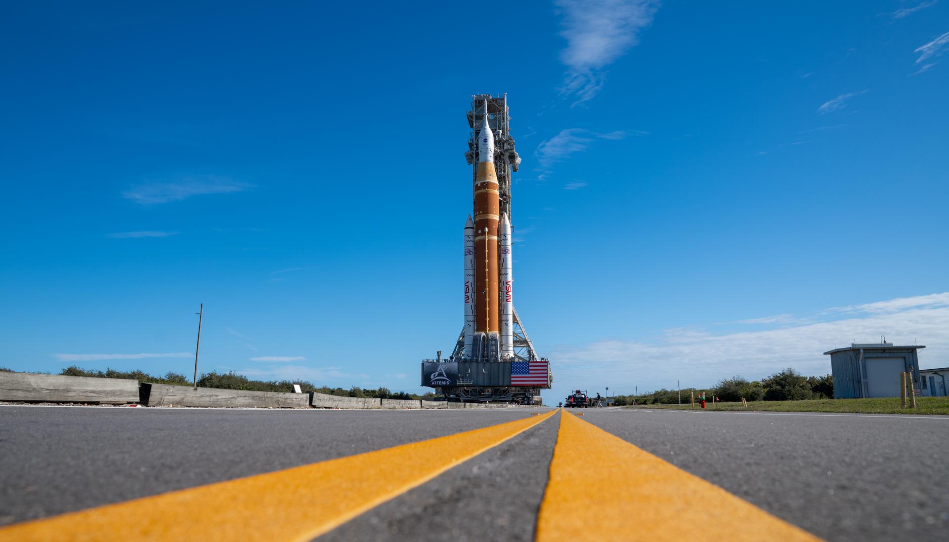 This image shows NASA’s SLS (Space Launch System) and Orion spacecraft rolling out of the Vehicle Assembly Building at NASA’s Kennedy Space Center. NASA's massive Crawler-Transporter, upgraded for the Artemis program, carries the powerful SLS rocket and Orion spacecraft on the Mobile Launcher from the Vehicle Assembly Building to Launch Pad 39B at Kennedy Space Center in preparation for the Artemis II mission.