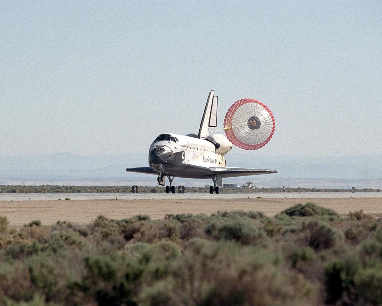 NASA/EDWARDS AFB, CALIF. -- With its drag chute deployed, Endeavour lands on runway 22 at Edwards Air Force Base, Calif., at 12:10:42 p.m. EDT after a mission of 11 days, 12 hours, 54 minutes to the International Space Station on mission STS-100. The orbiter and its crew of seven logged about 4.9 million statute miles in 186 orbits. Due to unfavorable weather conditions, landing at KSC was waved off. The landing marked the third consecutive landing at EAFB.    