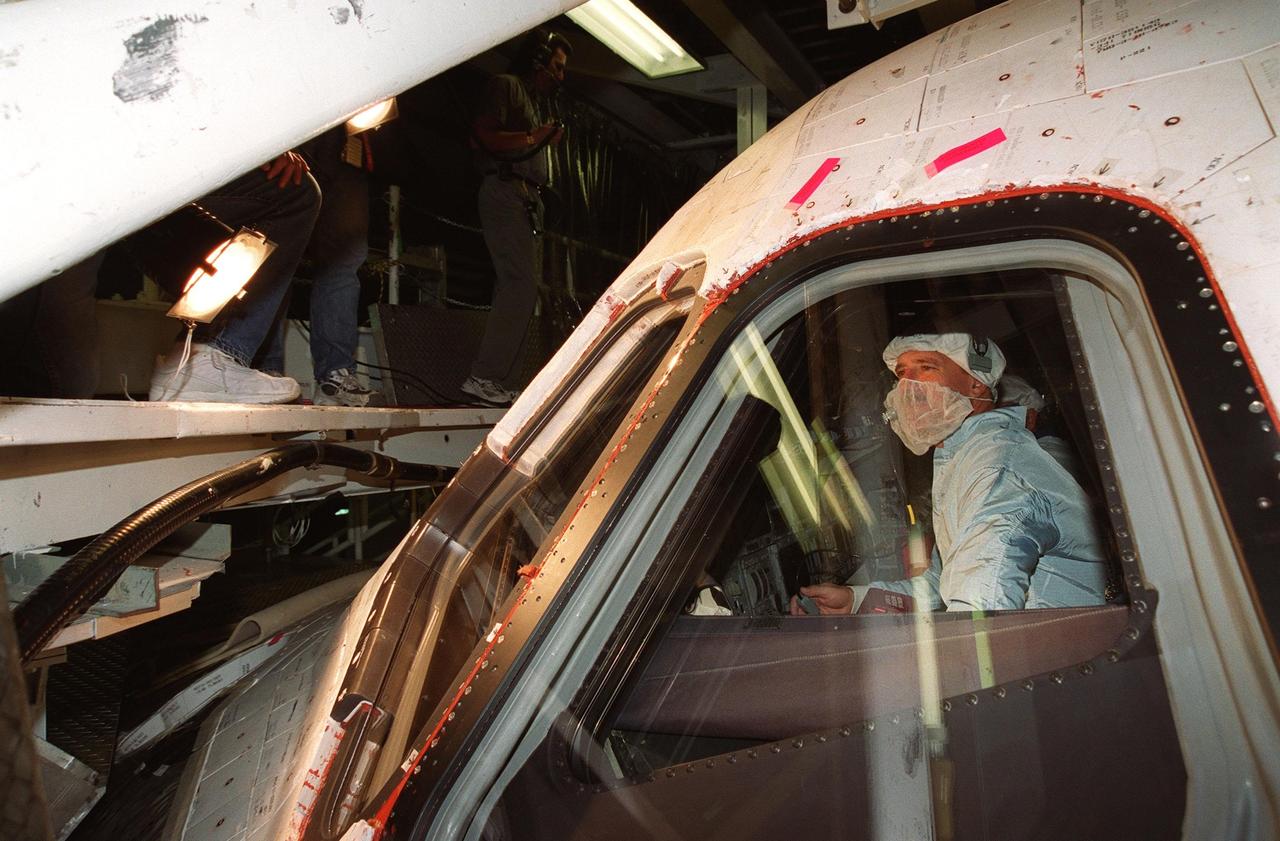 KENNEDY SPACE CENTER, FLA. -- During Crew Equipment Interface Test activities, STS-105 Commander Scott “Doc” Horowitz checks out the orbiter Discovery in Orbiter Processing Facility bay 2. STS-105 is the 11th mission to the International Space Station. The payload includes the Multi-Purpose Logistics Module Leonardo, which was built by the Italian Space Agency. Leonardo will be outfitted with 12 racks of experiments and equipment. Discovery is scheduled to launch July 12 from Launch Pad 39A
