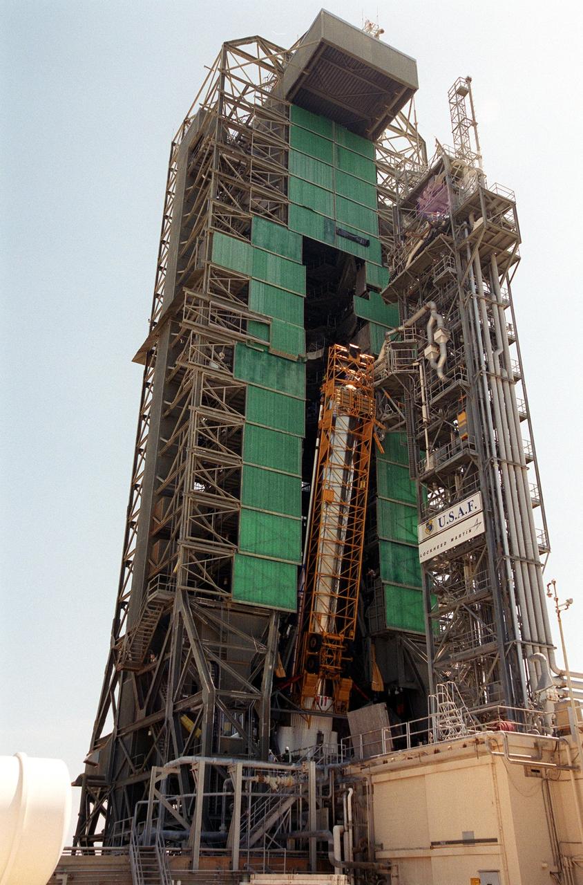 The first stage of the Geostationary Operational Environmental Satellite-M (GOES-M) Atlas II rocket is raised to a nearly vertical position on the gantry on Complex 36-A, Cape Canaveral Air Force Station. It will be raised and lifted up the gantry for mating with other stages. The last in the current series of advanced geostationary weather satellites in service, GOES-M has a new instrument not on earlier spacecraft, a Solar X-ray Imager that can be used in forecasting space weather, the effects of solar storms that create electromagnetic disturbances on earth that affect other satellites, communications and power grids. GOES-M is scheduled to launch from Cape Canaveral Air Force Station July 15