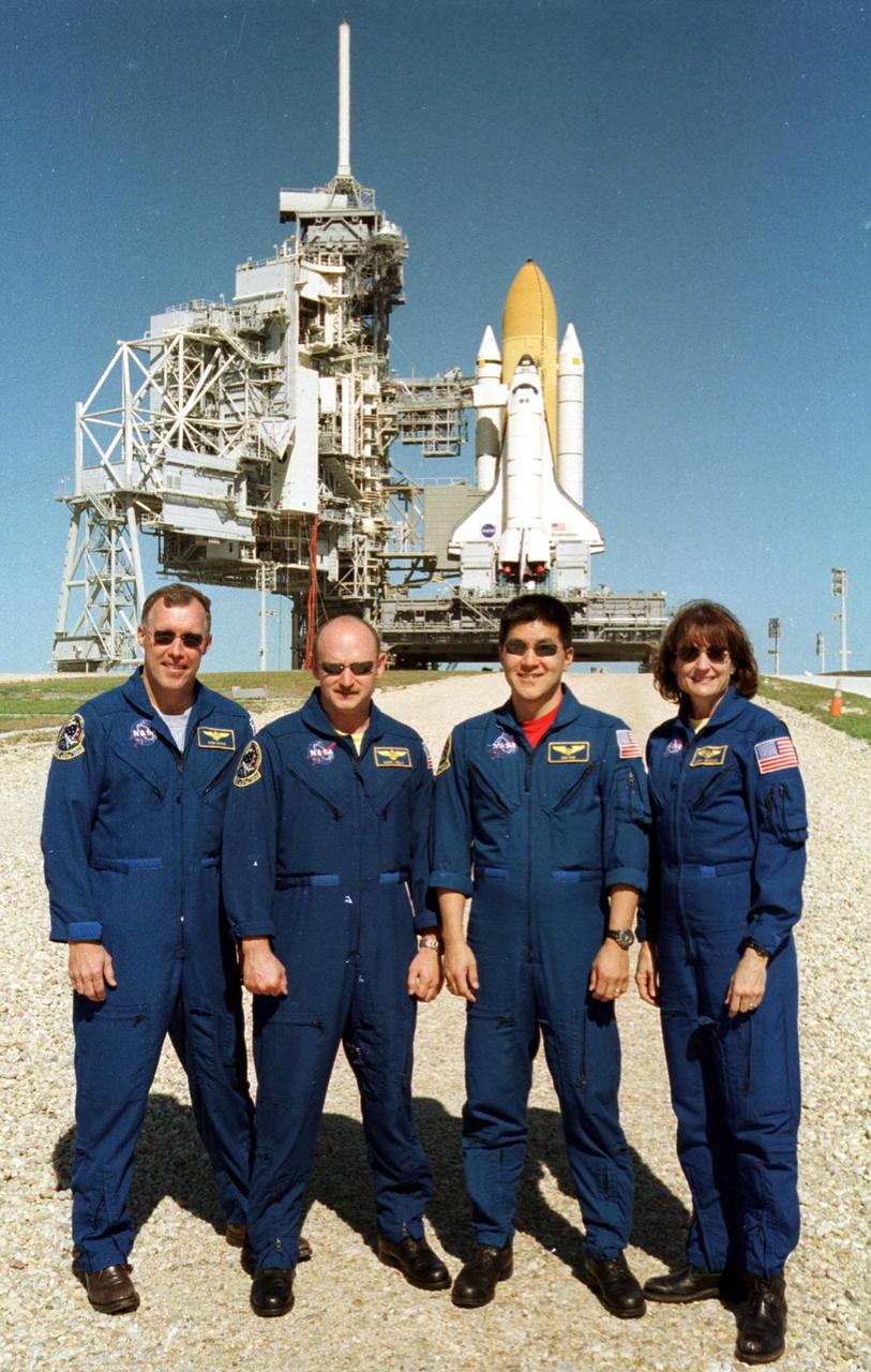 KENNEDY SPACE CENTER, Fla. --  On Launch Pad 39B, the STS-108 crew pause for a photo during Terminal Countdown Demonstration Test activities, which include emergency exit from the launch pad and a simulated launch countdown.  From left are Commander Dominic L. Gorie, Pilot Mark E. Kelly, and Mission Specialists Daniel M. Tani and Linda A. Godwin. STS-108 is a Utilization Flight that will carry the replacement Expedition 4 crew to the International Space Station, as well as the Multi-Purpose Logistics Module Raffaello, filled with supplies and equipment.  The l1-day mission is scheduled for launch Nov. 29 on Space Shuttle Endeavour