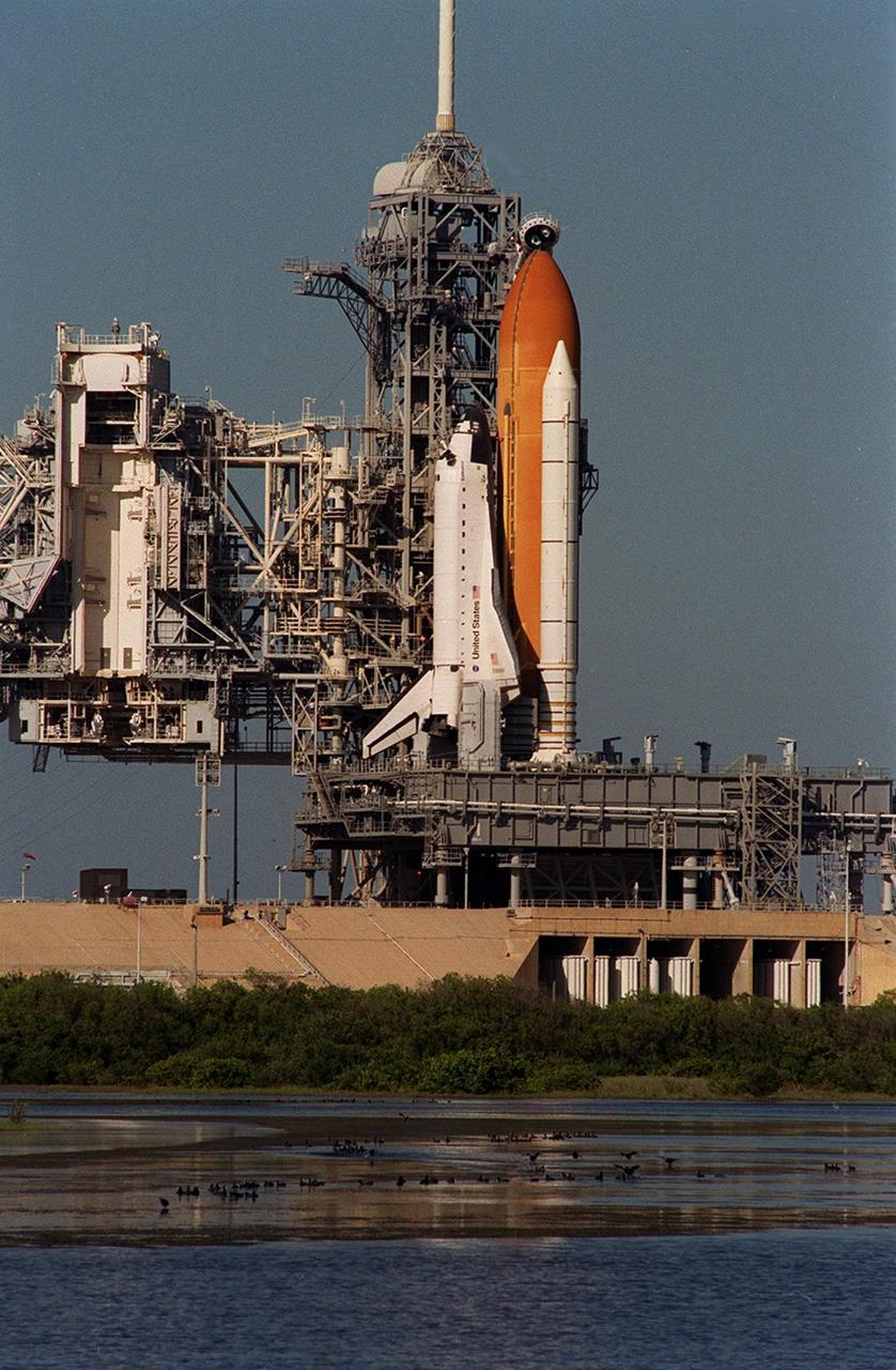 KENNEDY SPACE CENTER, Fla. --   Space Shuttle Endeavour sits on Launch Pad 39B after the Nov. 29 launch of mission STS-108 was scrubbed.  Birds of various species wade in the shallow waters alongside the pad.   The Rotating Service Structure (left) is still open.  Mission STS-108 is a Utilization Flight and will carry the Expedition 4 crew and the Multi-Purpose Logistics Module Raffaello, filled with supplies, equipment and experiments
