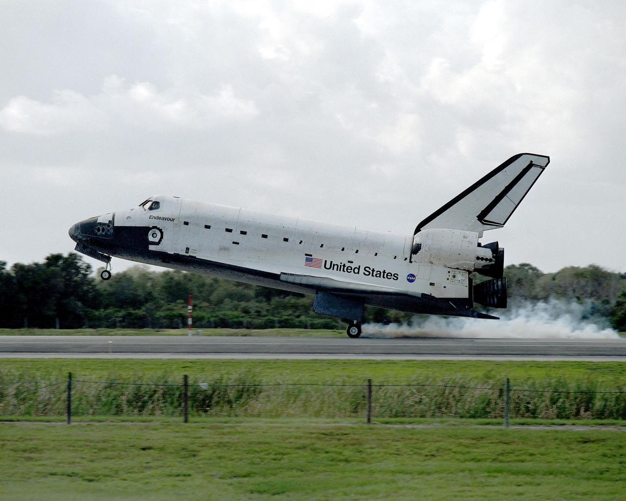 KENNEDY SPACE CENTER, FLA. --   Endeavour raises dust as it glides to a smooth landing on Runway 15 at the KSC Shuttle Landing Facility, completing mission STS-108.  Endeavour carries both the mission crew and the Expedition 3 crew - Commander Frank Culbertson and cosmonauts Vladimir Dezhurov and Mikhail Tyurin - who are returning to Earth after 129 days in space on the International Space Station.  After a mission-elapsed time of 11 days, 19 hours and 35 minutes, Endeavour had main gear touchdown at 12:55:10 p.m. EST (17:55:10 GMT).  Nose gear touchdown occurred at 12:55:23 p.m. (17:55:23 GMT); wheel stop at 12:56:13 p.m. (17:56:13 GMT). Rollout distance was 8,941 feet.  The landing is the 57th at KSC in the history of the program   STS-108 was the 12th mission to the Space Station.  This mission was the 107th flight in the Shuttle program and the 17th flight for the orbiter