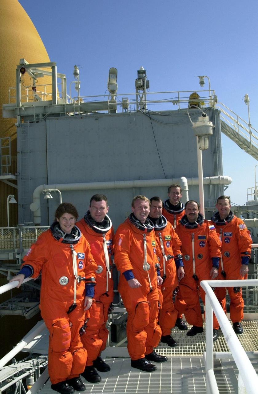 At the 215-foot level of the Fixed Service Structure, Launch Pad 39B, the STS-102 crew pose for a photograph. Standing, left to right, are Mission Specialist Susan Helms; Pilot James Kelly; Mission Specialists Andrew Thomas and Paul Richards; Commander James Wetherbee; and Mission Specialists Yury Usachev and James Voss. Voss, Helms and Usachev are the Expedition Two crew going to the International Space Station for their four-month rotation. Expedition One will return to Earth with Discovery. STS-102 is the eighth construction flight to the Space Station, with Space Shuttle Discovery carrying the Multi-Purpose Logistics Module Leonardo. Launch on mission STS-102 is scheduled for March 8