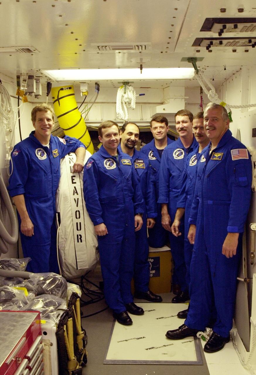 The crew on mission STS-100 poses in the White Room during Terminal Countdown Demonstration Test activities. Standing, from left, are Mission Specialists Scott E. Parazynski, Yuri Lonchakov, and Umberto Guidoni; Pilot Jeffrey S. Ashby; Commander Kent V. Rominger; Mission Specialist Chris A. Hadfield; and Mission Specialist John L. Phillips. The TCDT includes emergency escape training, payload bay walkdown, and a simulated launch countdown. Launch of Space Shuttle Endeavour on mission STS-100 is targeted for April 19 at 2:41 p.m. EDT from Launch Pad 39A