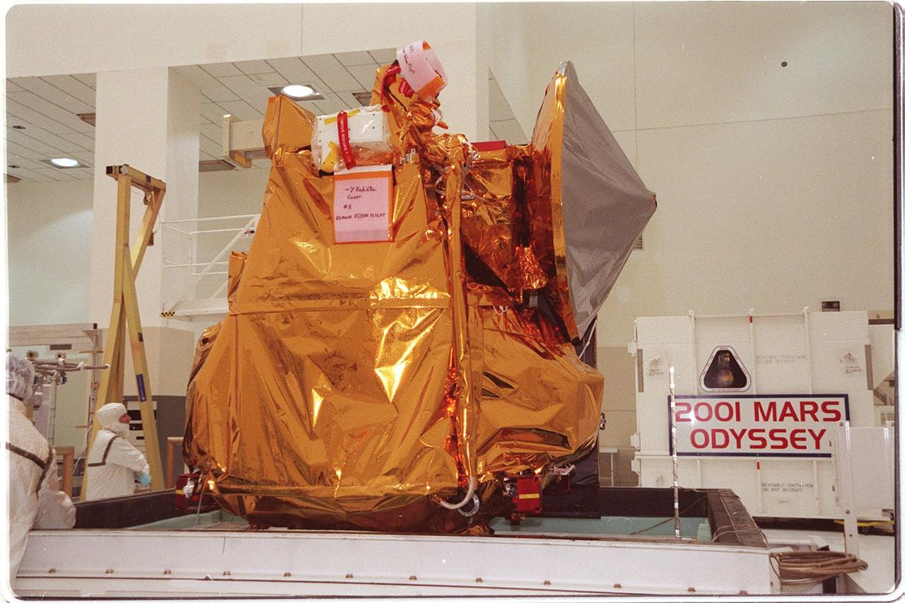 In the Spacecraft Assembly and Encapsulation Facility 2, the 2001 Mars Odyssey spacecraft sits on a workstand, ready for final assembly and checkout. That includes installation of two of the three science instruments, integration of the three-panel solar array, and a spacecraft functional test. Odyssey, which arrived from Denver, Colo., Jan. 4, will be launched aboard a Boeing Delta II vehicle from Pad A, Complex 17, CCAFS. Launch is planned for April 7, 2001 the first day of a 21-day planetary window. The spacecraft will arrive at Mars on Oct. 20, 2001, for insertion into an initial elliptical capture orbit. Its final operational altitude will be a 250-mile-high, Sun-synchronous polar orbit. Mars Odyssey will spend two years mapping the planet’s surface and measuring its environment