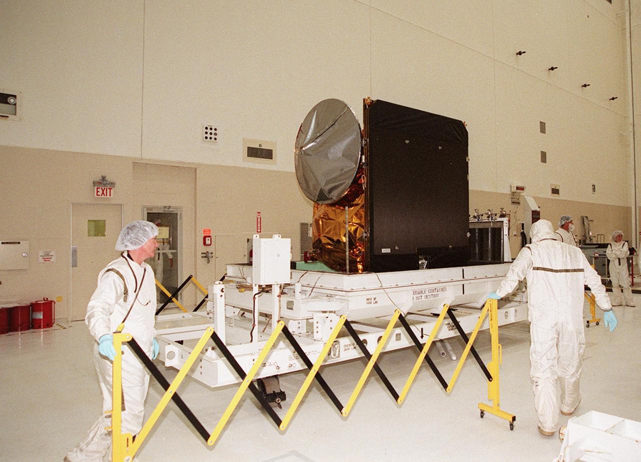 In the Spacecraft Assembly and Encapsulation Facility 2, workers place a protective barrier around the 2001 Mars Odyssey spacecraft. Odyssey will undergo final assembly and checkout in the SAEf-2, which includes installation of two of the three science instruments, integration of the three-panel solar array, and a spacecraft functional test. Odyssey, which arrived from Denver, Colo., Jan. 4, will be launched aboard a Boeing Delta II vehicle from Pad A, Complex 17, CCAFS. Launch is planned for April 7, 2001 the first day of a 21-day planetary window. The spacecraft will arrive at Mars on Oct. 20, 2001, for insertion into an initial elliptical capture orbit. Its final operational altitude will be a 250-mile-high, Sun-synchronous polar orbit. Mars Odyssey will spend two years mapping the planet’s surface and measuring its environment