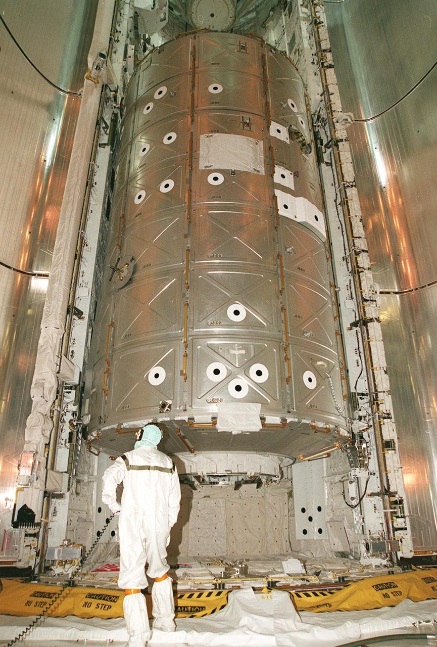 Viewed from the floor of the Payload Changeout Room, Destiny is inside Atlantis’ payload bay, waiting for closure of the payload bay doors. A key element in the construction of the International Space Station, Destiny is 28 feet long and weighs 16 tons. Destiny will be attached to the Unity node on the ISS using the Shuttle’s robot arm, seen here on the left side, with the help of an elbow camera attached to the arm (near the upper end of the lab in the photo). Measurements of the elbow camera revealed only a one-inch clearance from the U.S. Lab payload, which is under review. This research and command-and-control center is the most sophisticated and versatile space laboratory ever built. It will ultimately house a total of 23 experiment racks for crew support and scientific research. Destiny will fly on STS-98, the seventh construction flight to the ISS. Launch of STS-98 is scheduled for Jan. 19 at 2:11 a.m. EST