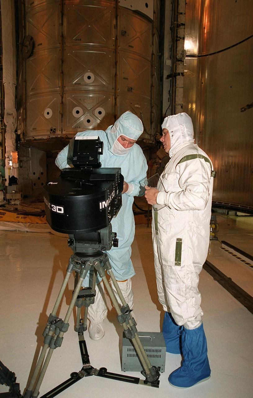 In the Payload Changeout Room at Launch Pad 39A, a film crew from IMAX prepares its 3-D movie camera to film the payload bay door closure on Atlantis. Behind them is the payload, the U.S. Laboratory Destiny, which will fly on mission STS-98, the seventh construction flight to the ISS. Destiny, a key element in the construction of the International Space Station, is 28 feet long and weighs 16 tons. This research and command-and-control center is the most sophisticated and versatile space laboratory ever built. It will ultimately house a total of 23 experiment racks for crew support and scientific research. Launch of Atlantis is Feb. 7 at 6:11 p.m. EST