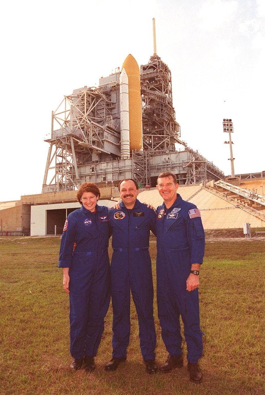 At the slidewire basket landing near Launch Pad 39B, the Expedition Two crew poses for a photograph. From left to right are Susan Helms, Yury Usachev and James Voss. They are flying on Space Shuttle Discovery (seen in the background) as mission specialists for STS-102, joining Commander James Wetherbee, Pilot James Kelly and Mission Specialists Andrew Thomas and Paul Richards for the eighth construction flight to the International Space Station. Voss, Helms and Usachev will be replacing the Expedition One crew, who will return to Earth with Discovery. STS-102 will be carrying the Multi-Purpose Logistics Module Leonardo. Launch on mission STS-102 is scheduled for March 8
