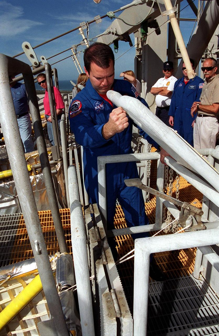 During emergency exit training on the Fixed Service Structure of Launch Pad 39B, STS-102 Mission Specialist Paul Richards takes a closer look at the lever that releases a slidewire basket, used for emergency exits from the launch pad, to the landing below. He and the rest of the crew are taking part in Terminal Countdown Demonstration Test activities, which include a simulated launch countdown. STS-102 is the eighth construction flight to the International Space Station, with Space Shuttle Discovery carrying the Multi-Purpose Logistics Module Leonardo. Launch on mission STS-102 is scheduled for March 8