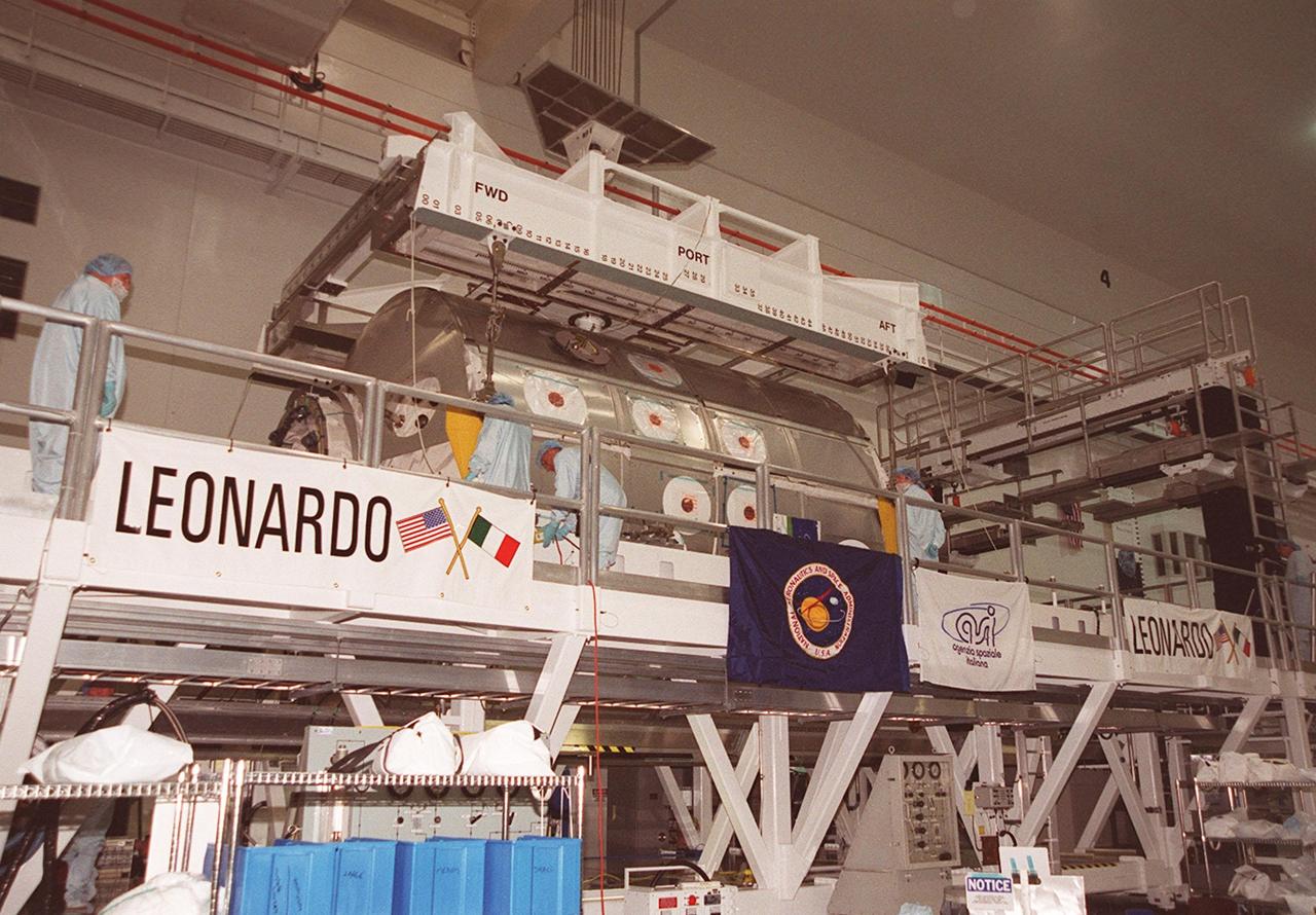 In the Space Station Processing Facility, workers attach an overhead crane to the Multi-Purpose Logistics Module Leonardo. The MPLM is being moved to the payload canister for transfer to Launch Pad 39B and installation in Space Shuttle Discovery. The Leonardo, one of Italy’s major contributions to the International Space Station program, is a reusable logistics carrier. It is the primary delivery system used to resupply and return Station cargo requiring a pressurized environment. Leonardo is the primary payload on mission STS-102 and will deliver up to 10 tons of laboratory racks filled with equipment, experiments and supplies for outfitting the newly installed U.S. Laboratory Destiny. STS-102 is scheduled to launch March 8 at 6:45 a.m. EST