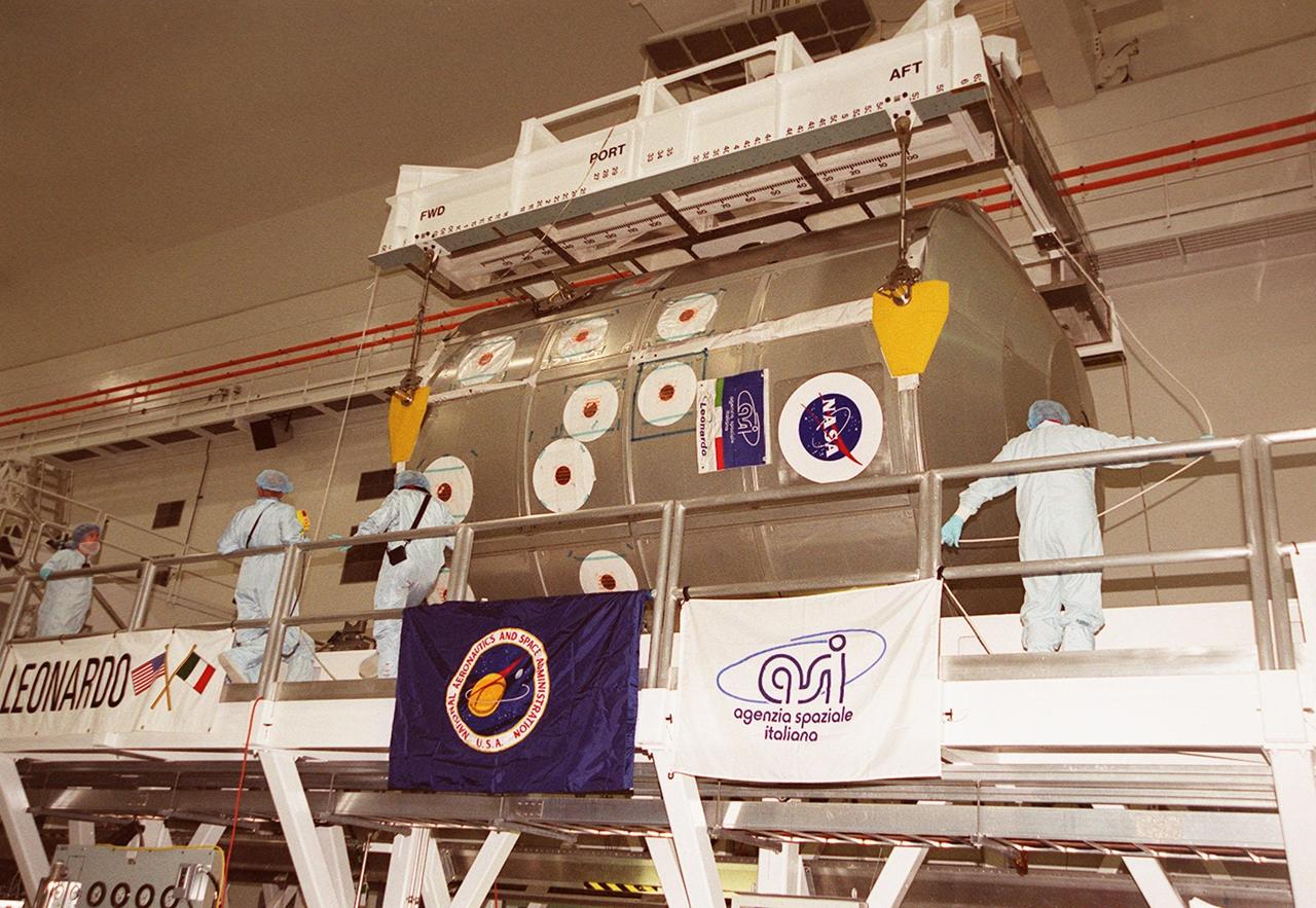 In the Space Station Processing Facility, an overhead crane begins lifting the Multi-Purpose Logistics Module Leonardo. The MPLM is being moved to the payload canister for transfer to Launch Pad 39B and installation in Space Shuttle Discovery. The Leonardo, one of Italy’s major contributions to the International Space Station program, is a reusable logistics carrier. It is the primary delivery system used to resupply and return Station cargo requiring a pressurized environment. Leonardo is the primary payload on mission STS-102 and will deliver up to 10 tons of laboratory racks filled with equipment, experiments and supplies for outfitting the newly installed U.S. Laboratory Destiny. STS-102 is scheduled to launch March 8 at 6:45 a.m. EST