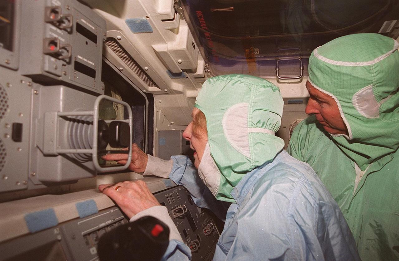 Lady Margaret Thatcher (left), former Prime Minister of Britain, takes a keen interest in the equipment inside the orbiter Endeavour. United Space Alliance technician Mike Parrish (right) provides information. The orbiter, which is in the Orbiter Processing Facility bay 2, is flying on mission STS-100, the ninth construction flight to the International Space Station.
