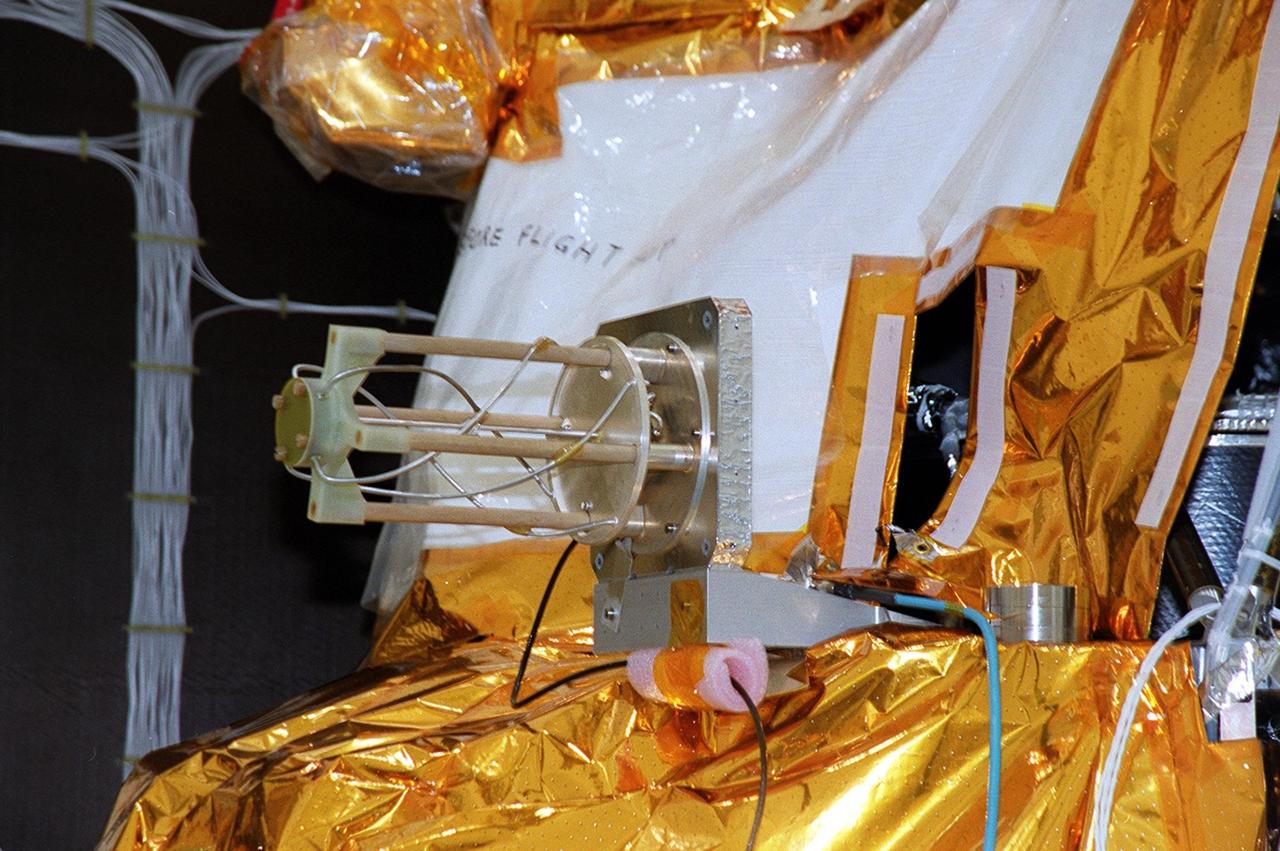 Shown in this closeup is the UHF antenna on the Mars Odyssey Orbiter. The antenna is undergoing testing in the Spacecraft Assembly and Encapsulation Facility (SAEF 2). The 2001 Mars Odyssey Orbiter, scheduled for launch April 7, 2001, contains three science instruments: THEMIS, the Gamma Ray Spectrometer (GRS), and the Mars Radiation Environment Experiment (MARIE). THEMIS will map the mineralogy and morphology of the Martian surface using a high-resolution camera and a thermal infrared imaging spectrometer. The GRS will achieve global mapping of the elemental composition of the surface and determine the abundance of hydrogen in the shallow subsurface. The MARIE will characterize aspects of the near-space radiation environment with regards to the radiation-related risk to human explorers