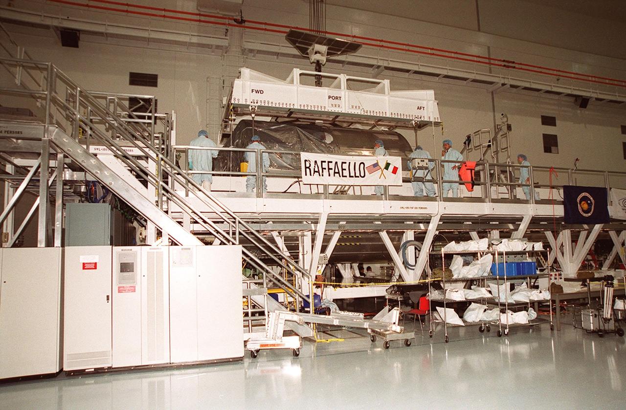 In the Space Station Processing Facility, an overhead crane is attached to the Multi-Purpose Logistics Module Raffaello in order to move the MPLM to the payload canister. Part of the payload on mission STS-100 to the International Space Station, Raffaello carries six system racks and two storage racks for the U.S. Lab. Launch of STS-100 is scheduled for April 19, 2001 at 2:41 p.m. EDT from Launch Pad 39A