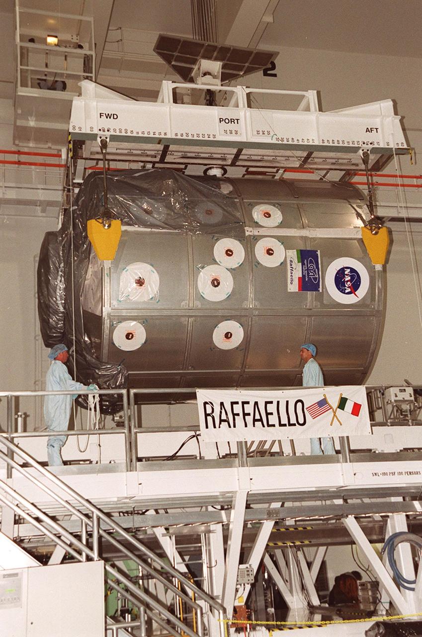 In the Space Station Processing Facility, the Multi-Purpose Logistics Module Raffaello rises off the workstand via an overhead crane that will move it to the payload canister. Part of the payload on mission STS-100 to the International Space Station, Raffaello carries six system racks and two storage racks for the U.S. Lab. Launch of STS-100 is scheduled for April 19, 2001 at 2:41 p.m. EDT from Launch Pad 39A