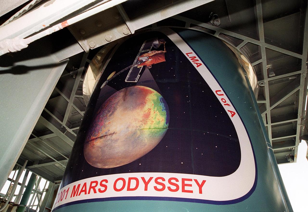 The Delta II rocket that will launch the Mars Odyssey spacecraft towards the Red Planet exhibits the mission logo (seen from the right). The Mars Odyssey is scheduled for launch April 7, 2001, at 11:02 a.m. EST. NASA’s latest explorer carries three scientific instruments to map the chemical and mineralogical makeup of Mars: a thermal-emission imaging system, a gamma ray spectrometer and a Martian radiation environment experiment. The imaging system will map the planet with high-resolution thermal images and give scientists an increased level of detail to help them understand how the mineralogy of the planet relates to the land forms. In addition, Odyssey will serve as a communications relay for U.S. and international landers arriving at Mars in 2003/2004