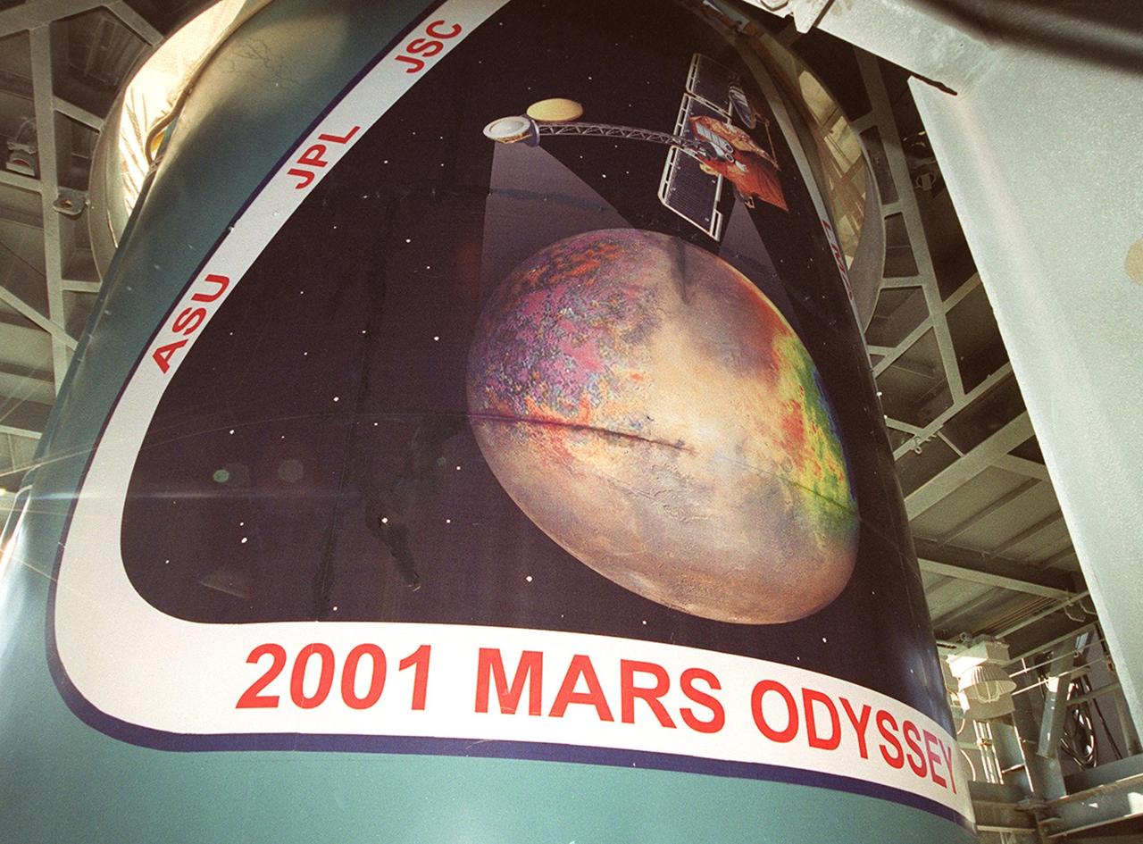 The Delta II rocket that will launch the Mars Odyssey spacecraft towards the Red Planet exhibits the mission logo (seen from the left). The Mars Odyssey is scheduled for launch April 7, 2001, at 11:02 a.m. EST. NASA’s latest explorer carries three scientific instruments to map the chemical and mineralogical makeup of Mars: a thermal-emission imaging system, a gamma ray spectrometer and a Martian radiation environment experiment. The imaging system will map the planet with high-resolution thermal images and give scientists an increased level of detail to help them understand how the mineralogy of the planet relates to the land forms. In addition, Odyssey will serve as a communications relay for U.S. and international landers arriving at Mars in 2003/2004