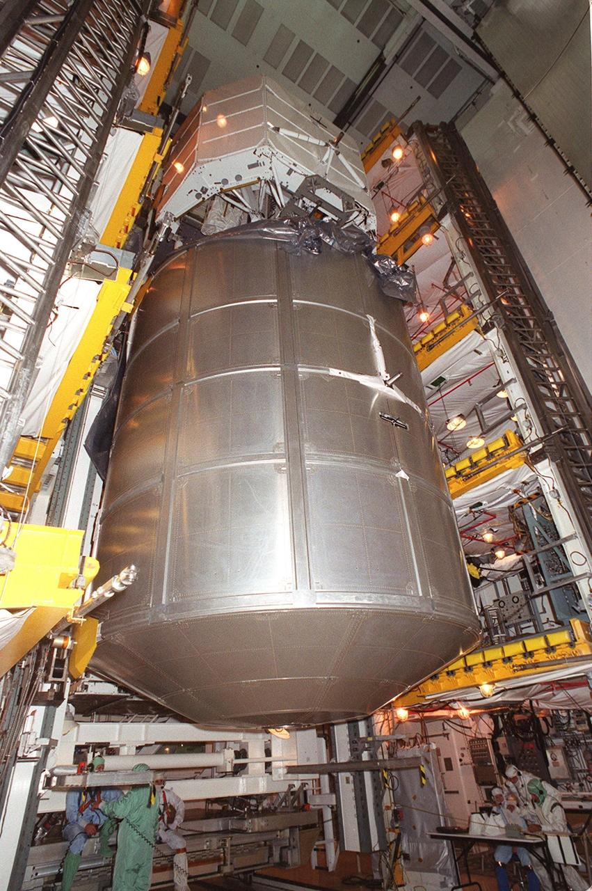  At Launch Pad 39A, the payload on mission STS-100 continues moving out of the payload canister and into the payload changeout room. At the top is the Canadian robotic arm, the SSRMS, and below it is the Multi-Purpose Logistics Module Raffaello. The SSRMS is capable of handling large payloads and assisting with docking the Space Shuttle. It is crucial to the continued assembly of the International Space Station. Raffaello carries six system racks and two storage racks for the U.S. Lab. Launch of mission STS-100 is scheduled for April 19 at 2:41 p.m. EDT
