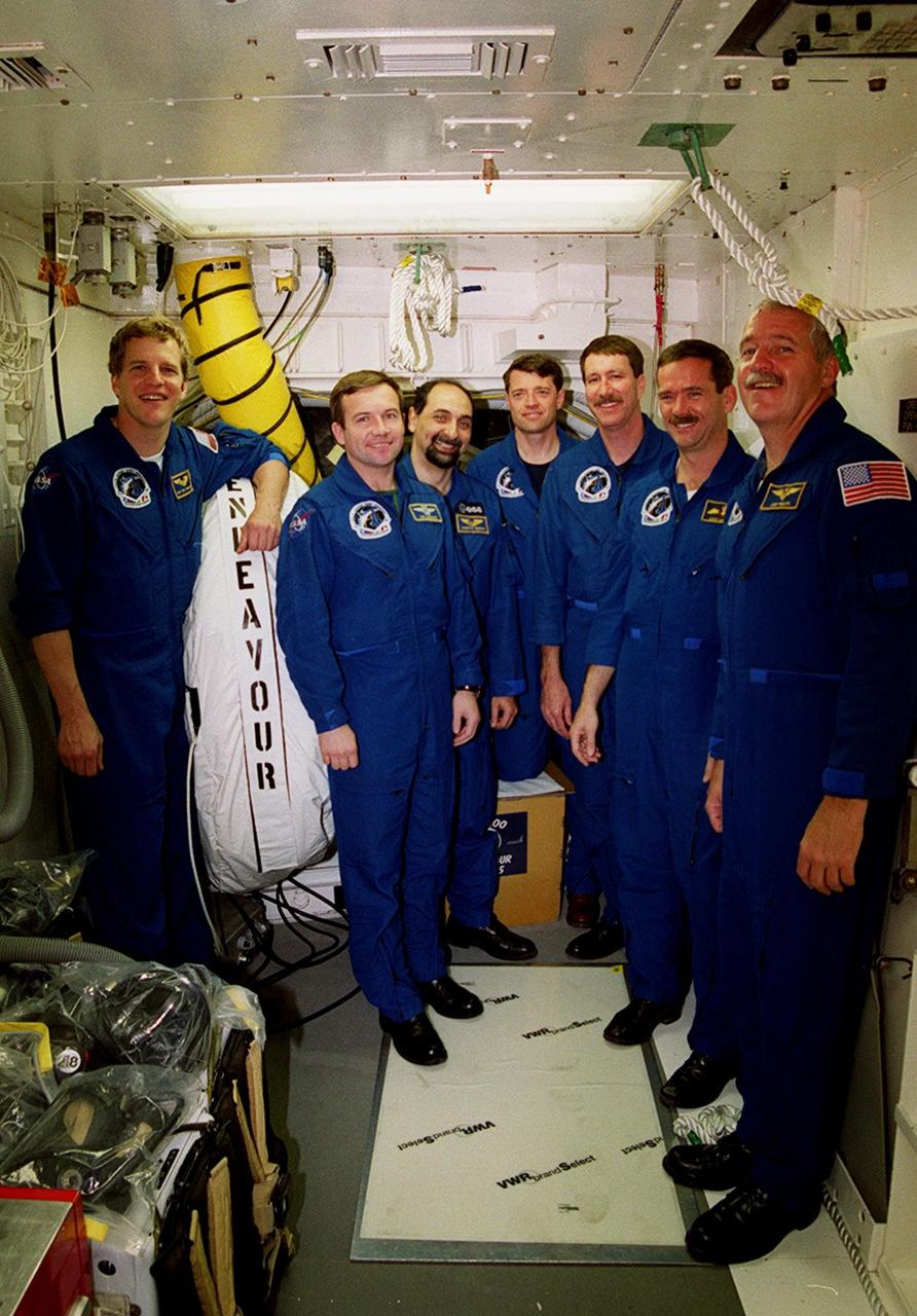 The crew on mission STS-100 poses in the White Room during Terminal Countdown Demonstration Test activities. Standing, from left, are Mission Specialists Scott E. Parazynski, Yuri Lonchakov, and Umberto Guidoni; Pilot Jeffrey S. Ashby; Commander Kent V. Rominger; and Mission Specialists Chris A. Hadfield and John L. Phillips. The TCDT includes emergency escape training, payload bay walkdown, and a simulated launch countdown. The primary payload comprises the Canadian robotic arm, SSRMS, and Multi-Purpose Logistics Module, Raffaello. Launch of Space Shuttle Endeavour on mission STS-100 is targeted for April 19 at 2:41 p.m. EDT from Launch Pad 39A