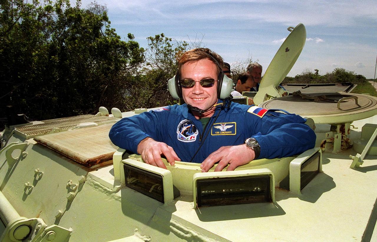 Ready to take the wheel on the M-113 armored carrier is STS-100 Mission Specialist Yuri V. Lonchakov, who is with the Russian Space and Aviation Agency. He and the rest of the crew are taking part in Terminal Countdown Demonstration Test activities, which include emergency escape training, payload walkdown and a simulated launch countdown. The tracked vehicle could be used by the crew in the event of an emergency at the pad during which the crew must make a quick exit from the area. The primary payload on mission STS-100 comprises the Canadian robotic arm, SSRMS, and Multi-Purpose Logistics Module, Raffaello. Launch of Space Shuttle Endeavour on mission STS-100 is targeted for April 19 at 2:41 p.m. EDT from Launch Pad 39A