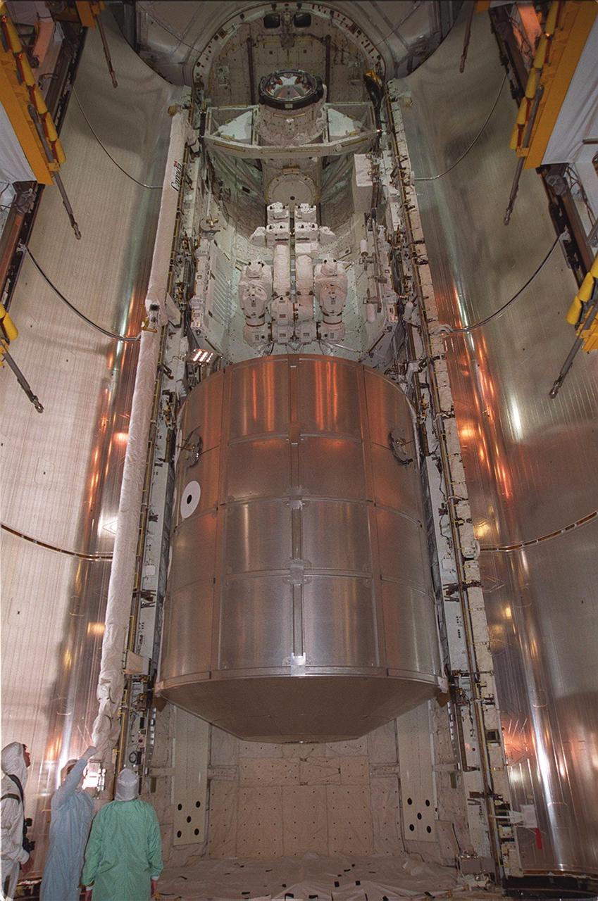 The STS-100 mission payload is transferred into the payload bay of Space Shuttle Endeavour. A t the top is the Canadian robotic arm, the SSRMS, and below it is the Multi-Purpose Logistics Module Raffaello. In the payload bay, the SSRMS is folded up on a u-shaped space lab pallet. The SSRMS is capable of handling large payloads and assisting with docking the Space Shuttle. It is crucial to the continued assembly of the International Space Station. Raffaello carries six system racks and two storage racks for the U.S. Lab. Launch of mission STS-100 is scheduled for April 19 at 2:41 p.m. EDT