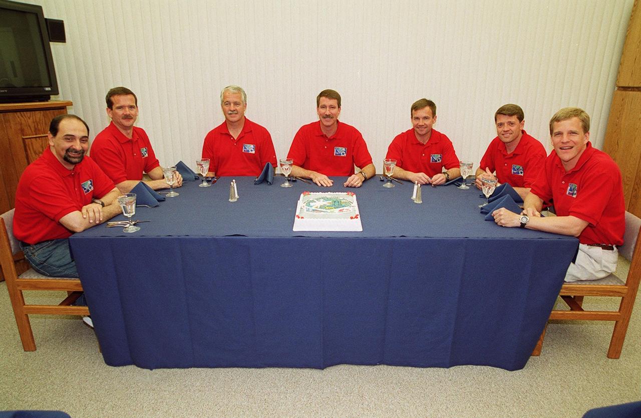 The STS-100 crew gathers for a snack and photo before suiting up for launch. Seated around the table, from left, are Mission Specialists Umberto Guidoni, Chris A. Hadfield and John L. Phillips; Commander Kent V. Rominger; Mission Specialist Yuri V. Lonchakov; Pilot Jeffrey S. Ashby; and Mission Specialist Scott E. Parazynski. The 11-day mission to the International Space Station will deliver and integrate the Spacelab Logistics Pallet/Launch Deployment Assembly, which includes the Space Station Remote Manipulator system and the UHF Antenna, and the Multi-Purpose Logistics Module Raffaello. The mission includes two planned spacewalks for installation of the SSRMS. The mission is also the inaugural flight of the MPLM Raffaello, carrying resupply stowage racks and resupply/return stowage platforms. Liftoff on mission STS-100 is scheduled at 2:41 p.m. EDT April 19